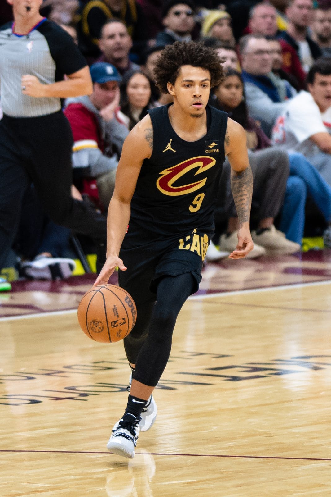 Craig Porter Jr. dribbles in the Cavaliers' black uniform with a wine-and-gold C and No. 9, at Rocket Mortgage FieldHouse, November 25, 2023