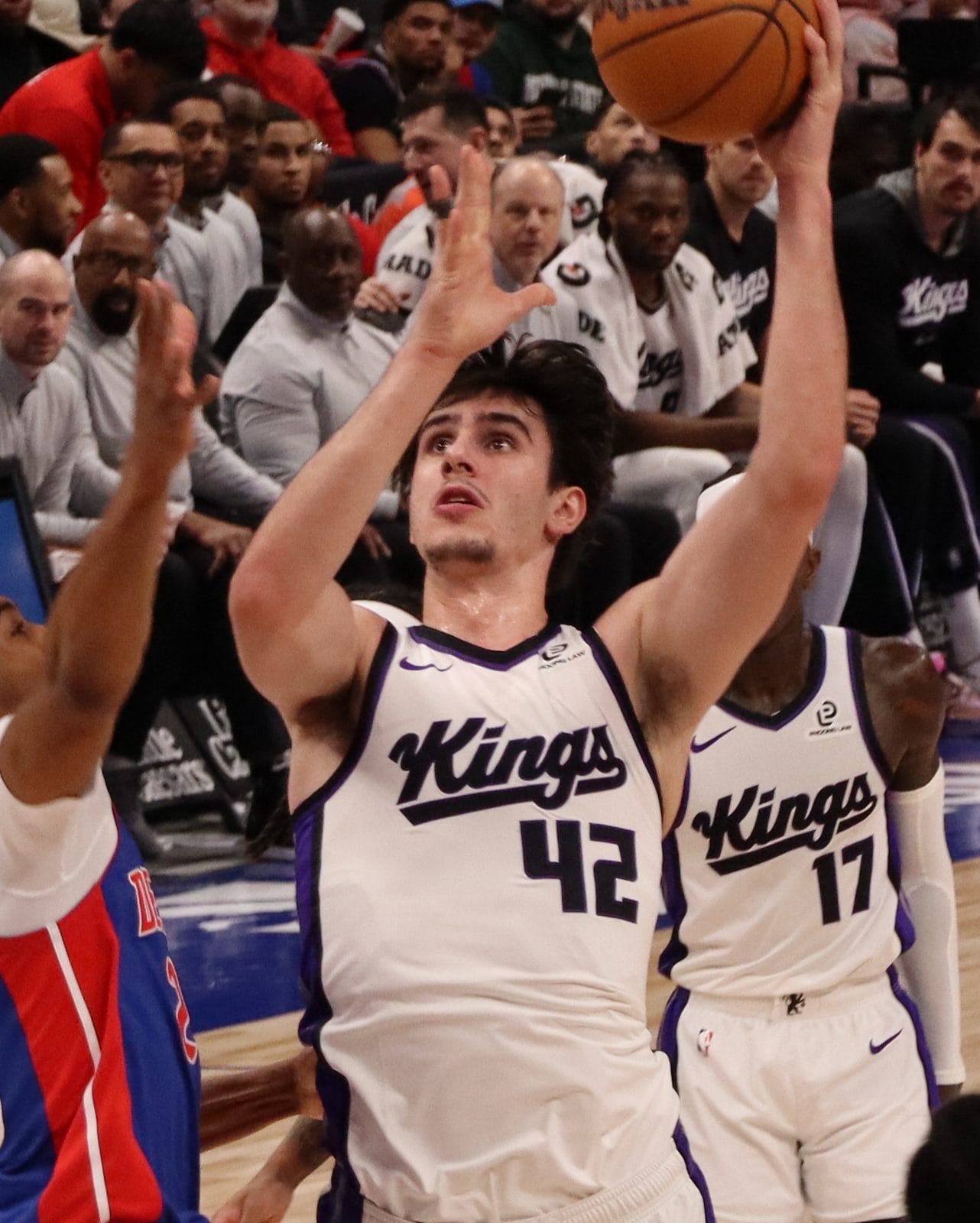 Maxime Raynaud goes up for a layup in the Kings' white uniform, Kings script over No. 42, against the Pistons, January 25, 2026