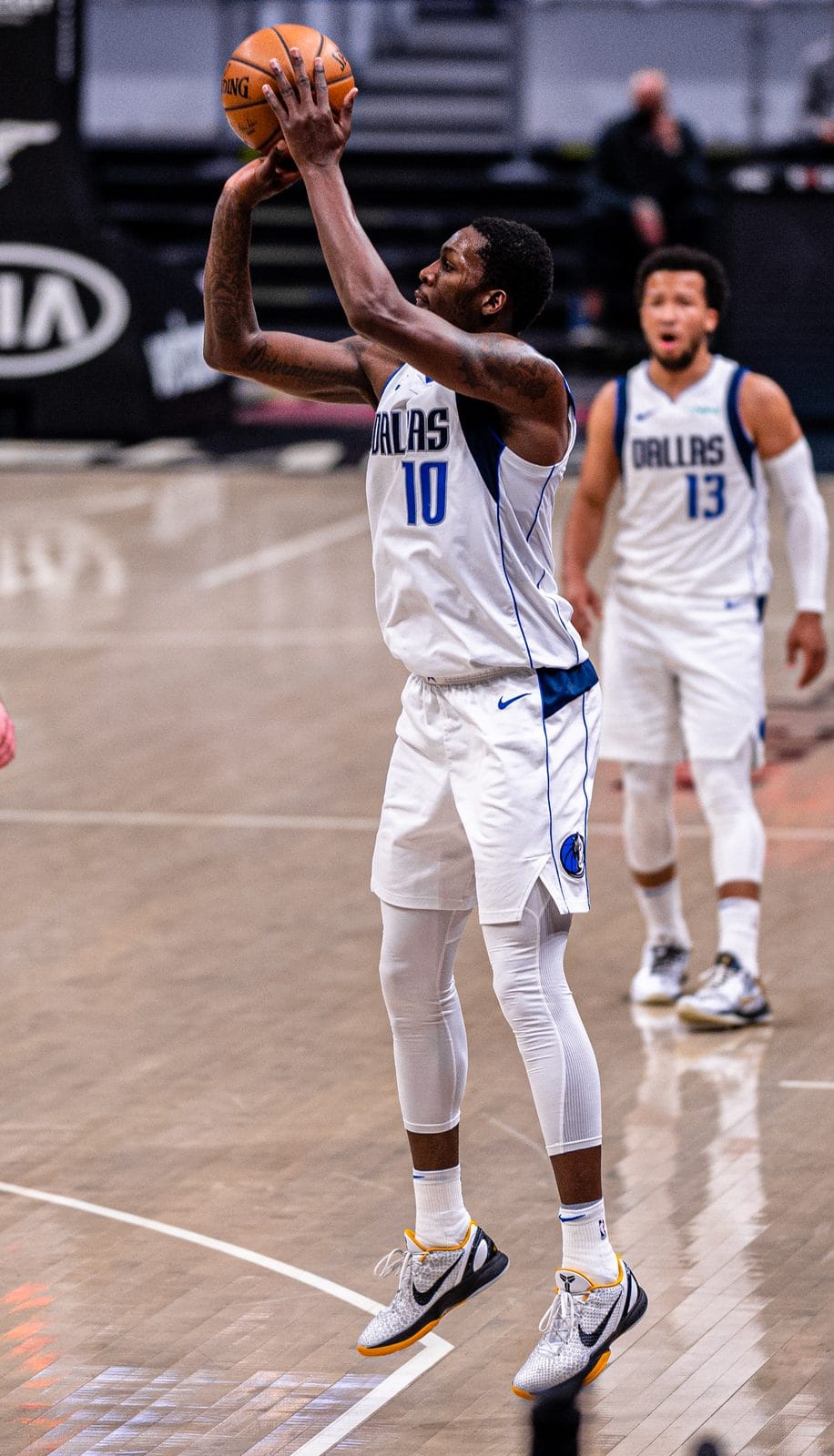 A Mavericks player in the white home-style DALLAS uniform, No. 10, shoots during a game against the Cavaliers in Cleveland, May 9, 2021