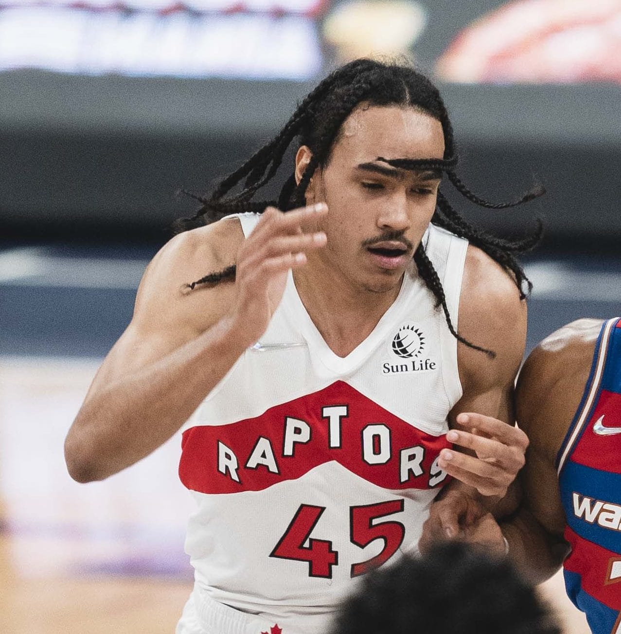 Dalano Banton in the Raptors' white uniform, RAPTORS in red over No. 45, at Capital One Arena, November 3, 2021