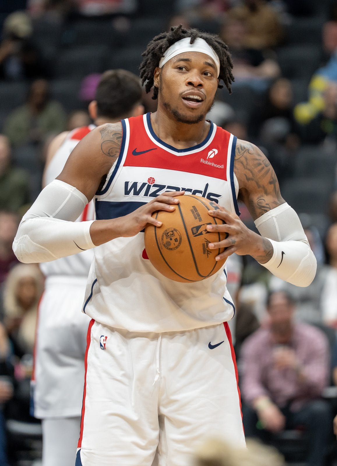 Richaun Holmes holds the ball in the Wizards' white uniform, WIZARDS across a navy stripe, at Capital One Arena, March 28, 2025