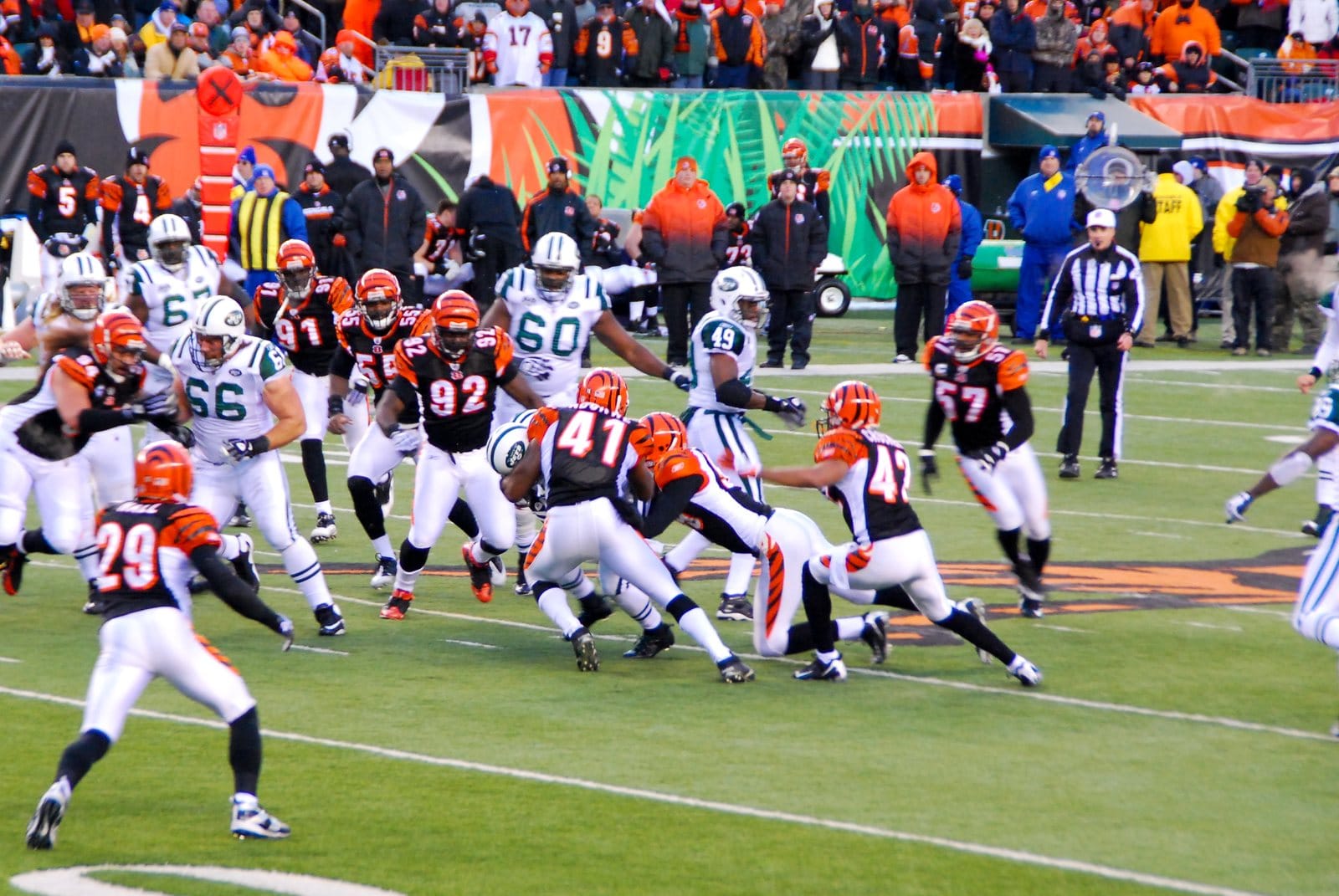 Bengals defenders in black home jerseys with orange tiger-stripe shoulders, white pants and tiger-striped orange helmets, against the Jets in the Wild Card game at Paul Brown Stadium in Cincinnati on Jan. 9, 2010