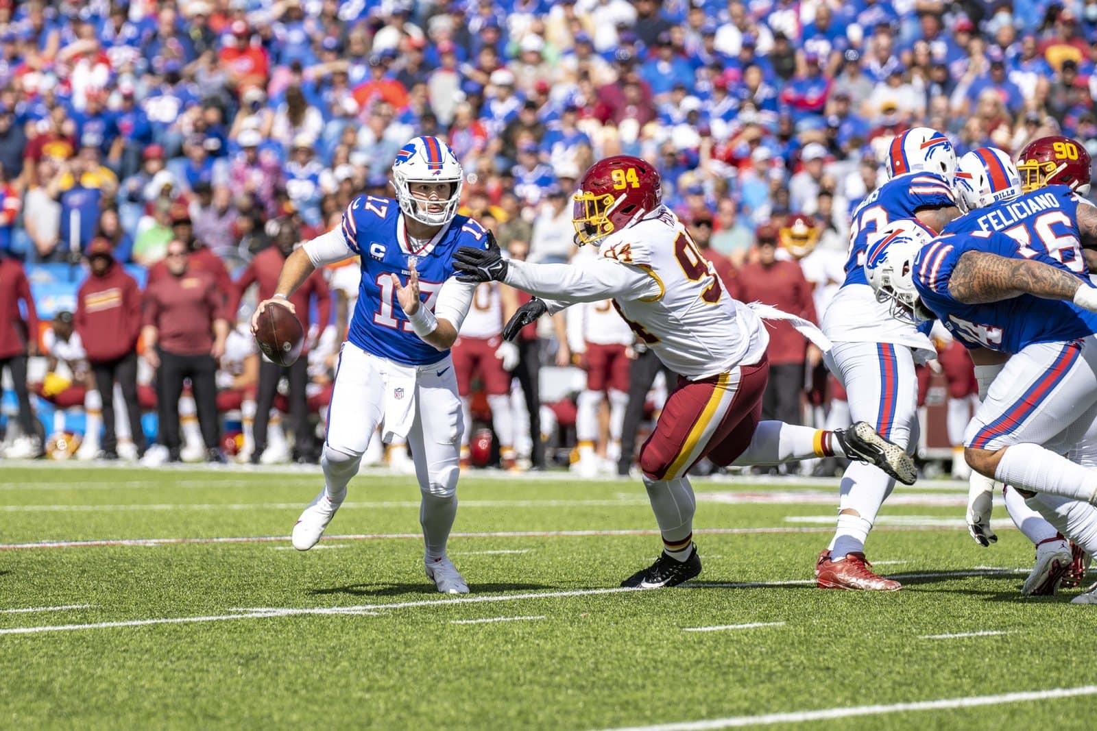 Bills quarterback Josh Allen in the royal blue home jersey, white pants and white helmet with the red charging-buffalo logo, against Washington at Highmark Stadium in Orchard Park, N.Y., on Sept. 26, 2021