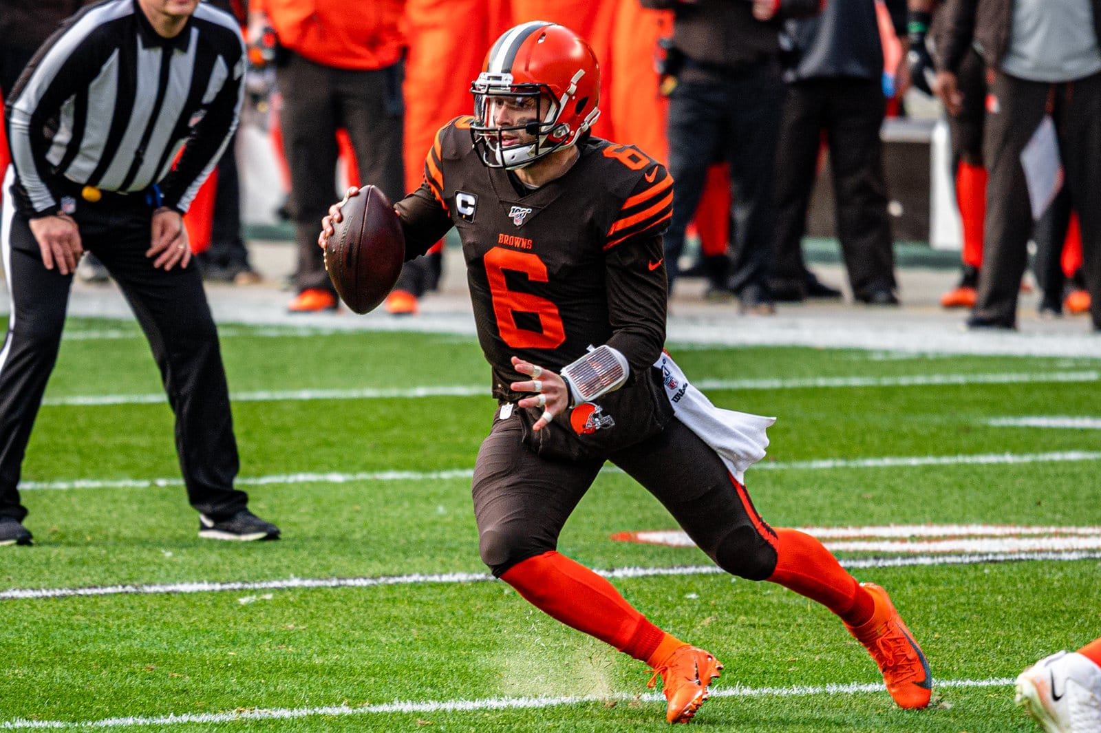 Browns quarterback Baker Mayfield scrambles in the brown home jersey with orange numbers, orange pants and the logo-free orange helmet, against the Bengals at FirstEnergy Stadium in Cleveland on Dec. 8, 2019