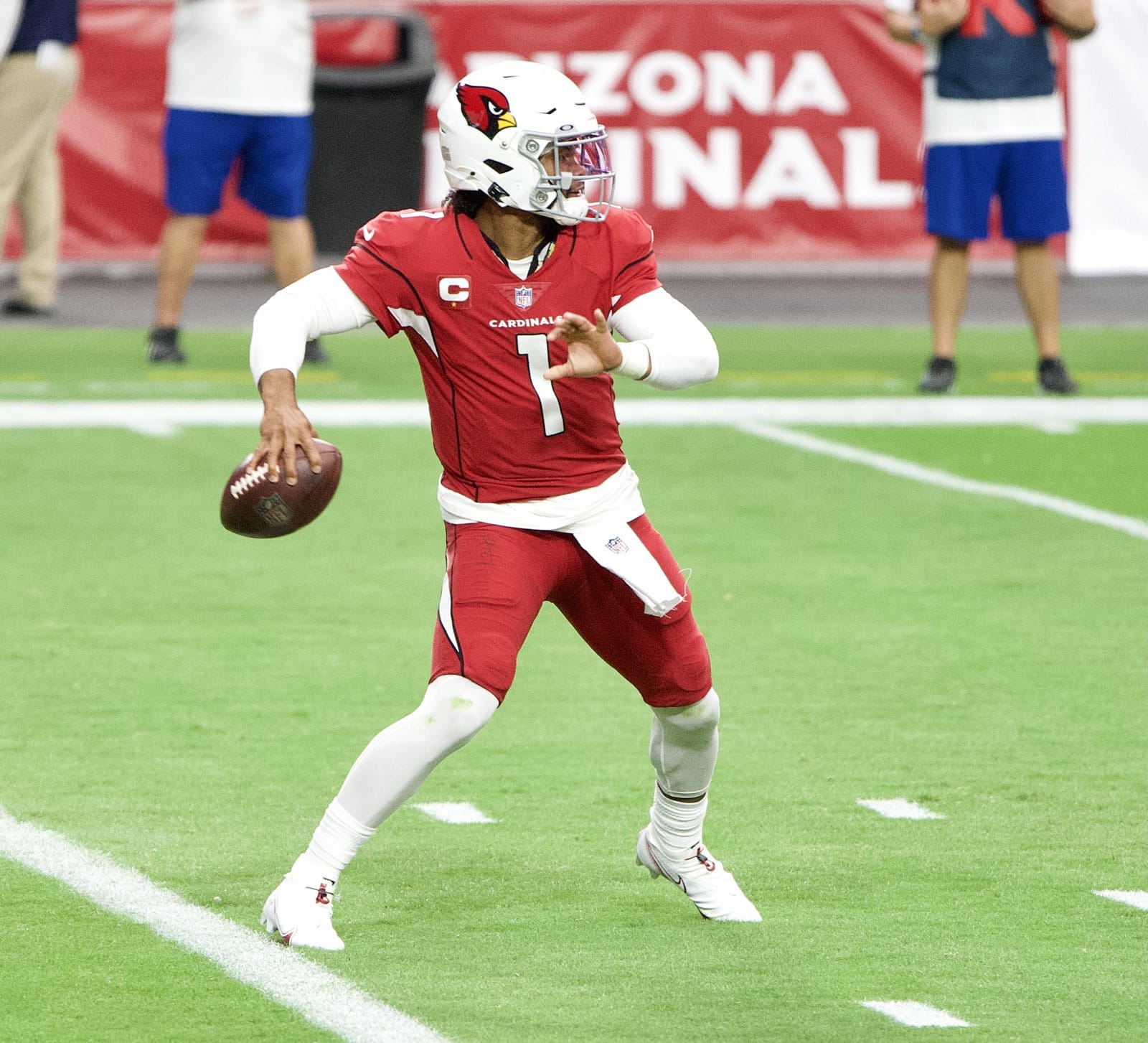 Cardinals quarterback Kyler Murray winds up to pass in the cardinal red home jersey, red pants and white helmet, against Washington at State Farm Stadium in Glendale, Ariz., on Sept. 20, 2020