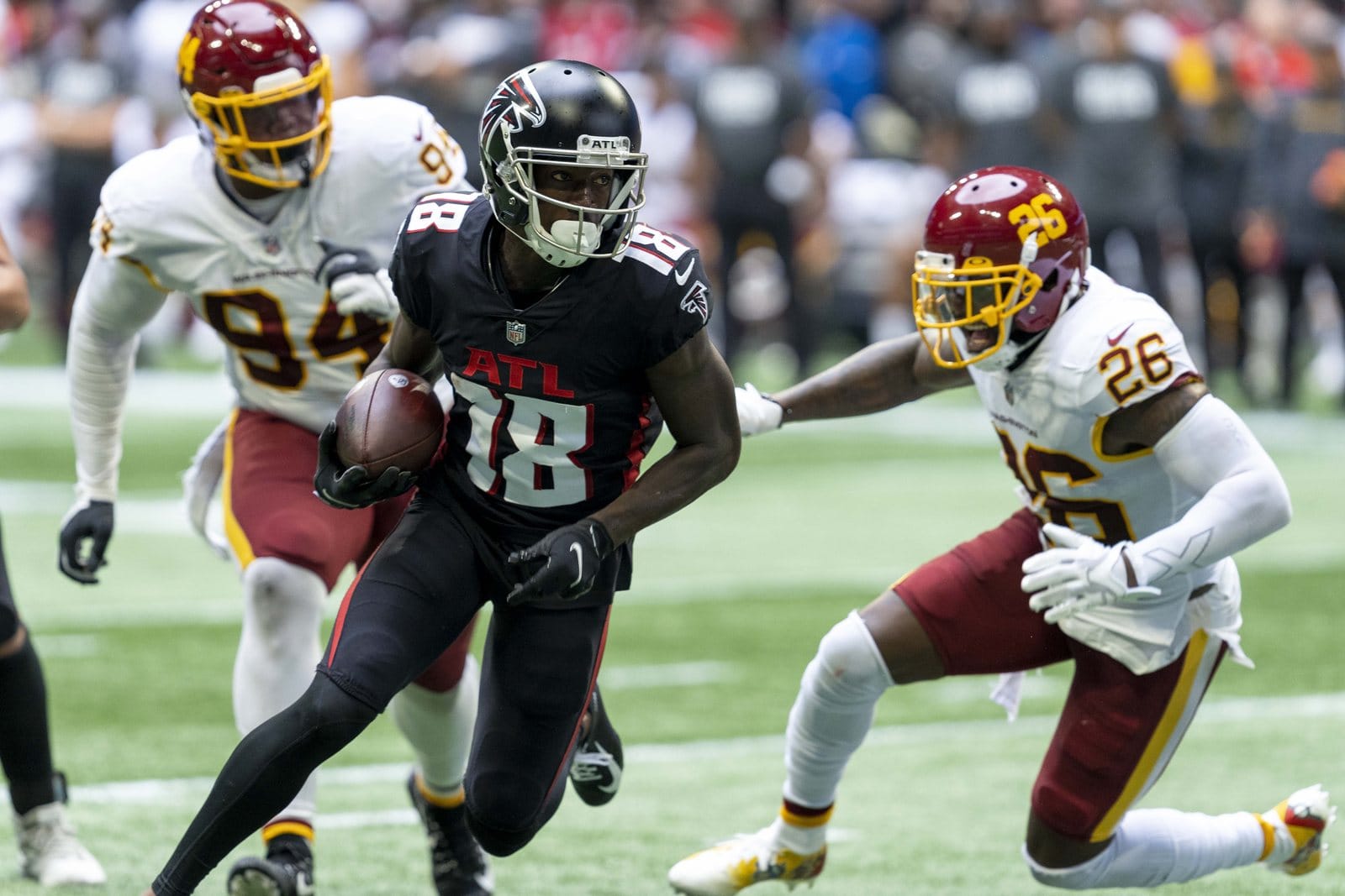 Falcons receiver Calvin Ridley runs in the black home jersey with ATL above the numbers, black pants and black helmet, against Washington at Mercedes-Benz Stadium in Atlanta on Oct. 3, 2021