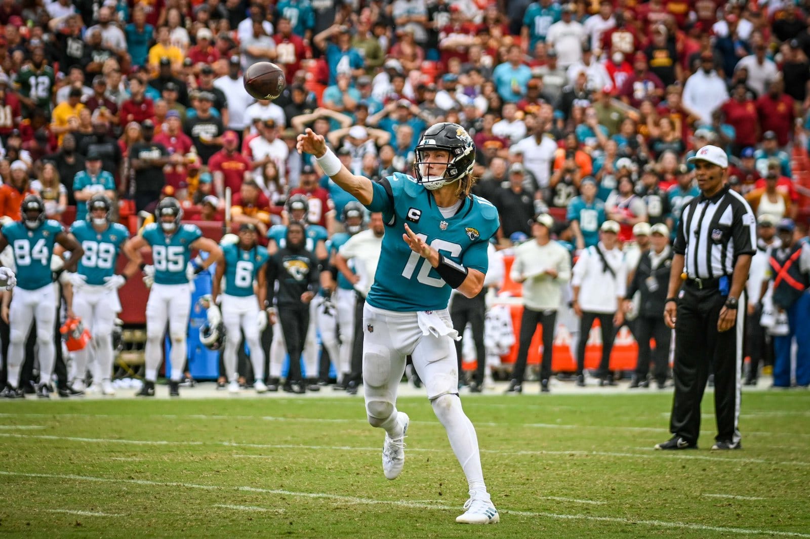 Jaguars quarterback Trevor Lawrence throws in the teal road jersey, white pants and black helmet against the Commanders at FedExField on Sept. 11, 2022