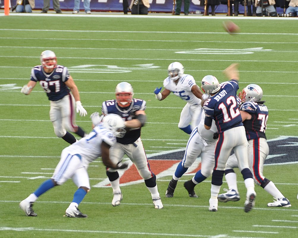 Patriots quarterback Tom Brady throws in the navy home jersey, silver pants and silver Flying Elvis helmet against the Colts at Gillette Stadium in Foxborough, Mass., on Dec. 4, 2011