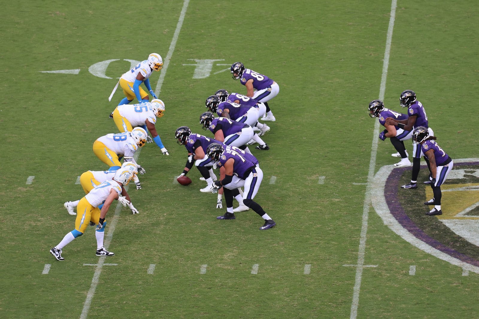 Ravens offense lines up in purple home jerseys, white pants and black helmets against the Chargers at M&T Bank Stadium in Baltimore on Oct. 17, 2021