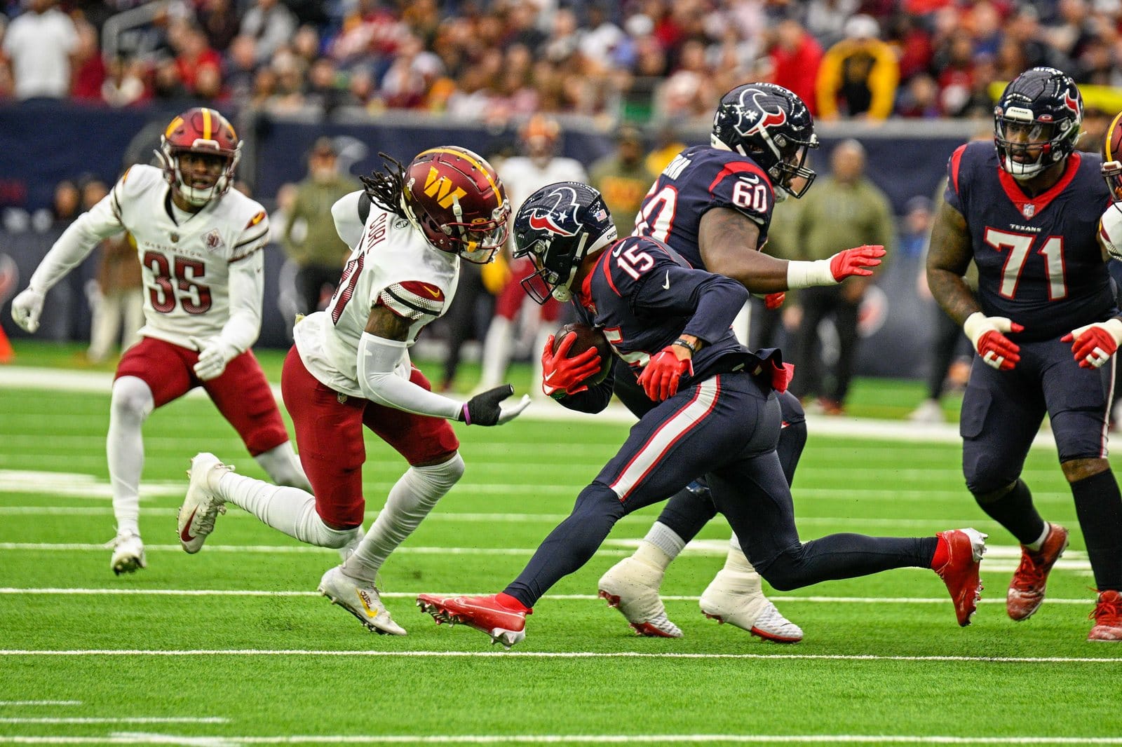 Texans players in Deep Steel Blue home jerseys with red trim, blue pants and blue helmets against Washington at NRG Stadium in Houston on Nov. 20, 2022