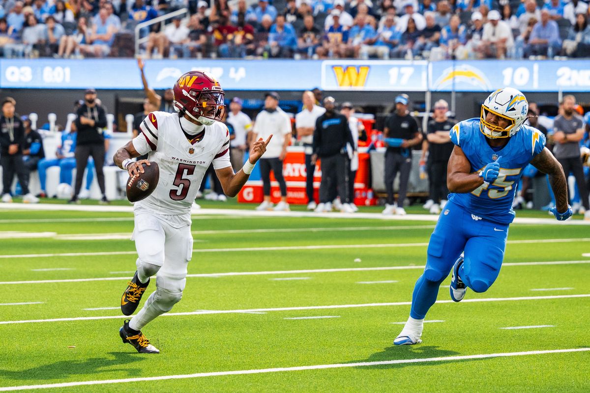 Washington Commanders quarterback Jayden Daniels in the white road uniform rolls out against the Los Angeles Chargers at SoFi Stadium in 2025