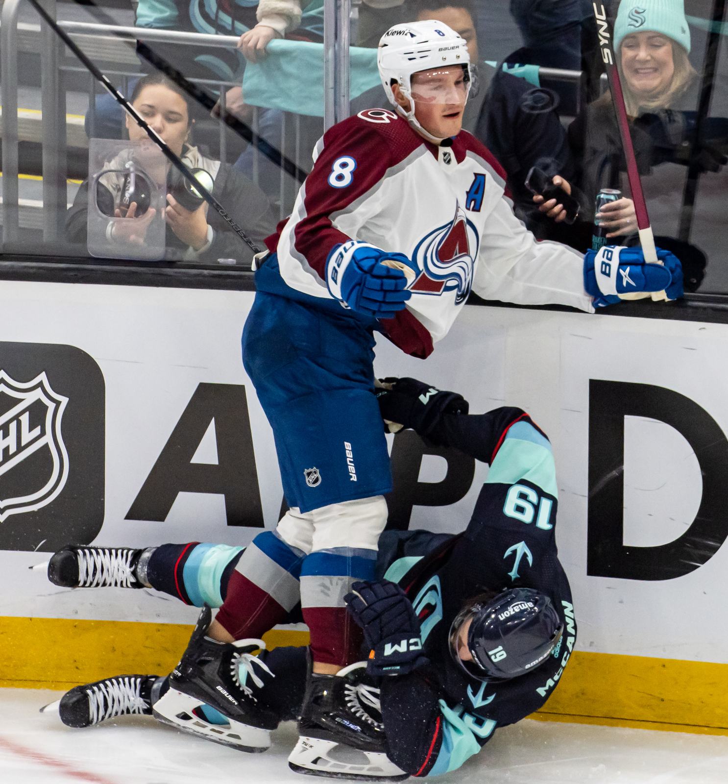 Cale Makar, wearing an A and No. 8 on the Avalanche's white road uniform with burgundy shoulders and the A crest, after a hit on the Kraken's Jared McCann in Game 4 of the 2023 first round, Climate Pledge Arena in Seattle, April 24, 2023