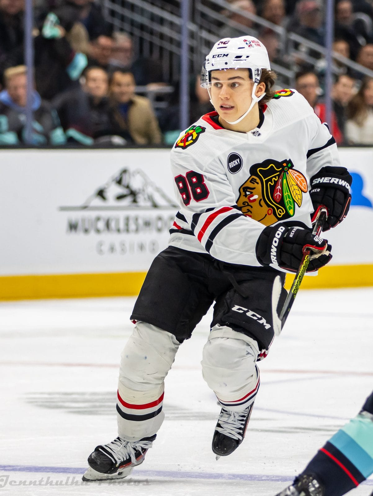 Connor Bedard in the Blackhawks' white road uniform with the team crest and red and black stripes, No. 98, at Climate Pledge Arena in Seattle, December 14, 2023