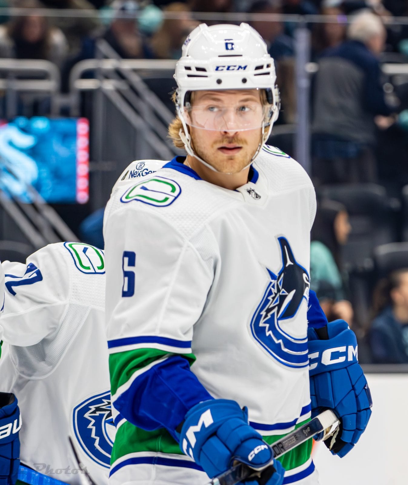 Brock Boeser in the Canucks' white road uniform with the orca crest and blue and green stripes, No. 6, at Climate Pledge Arena in Seattle, November 24, 2023