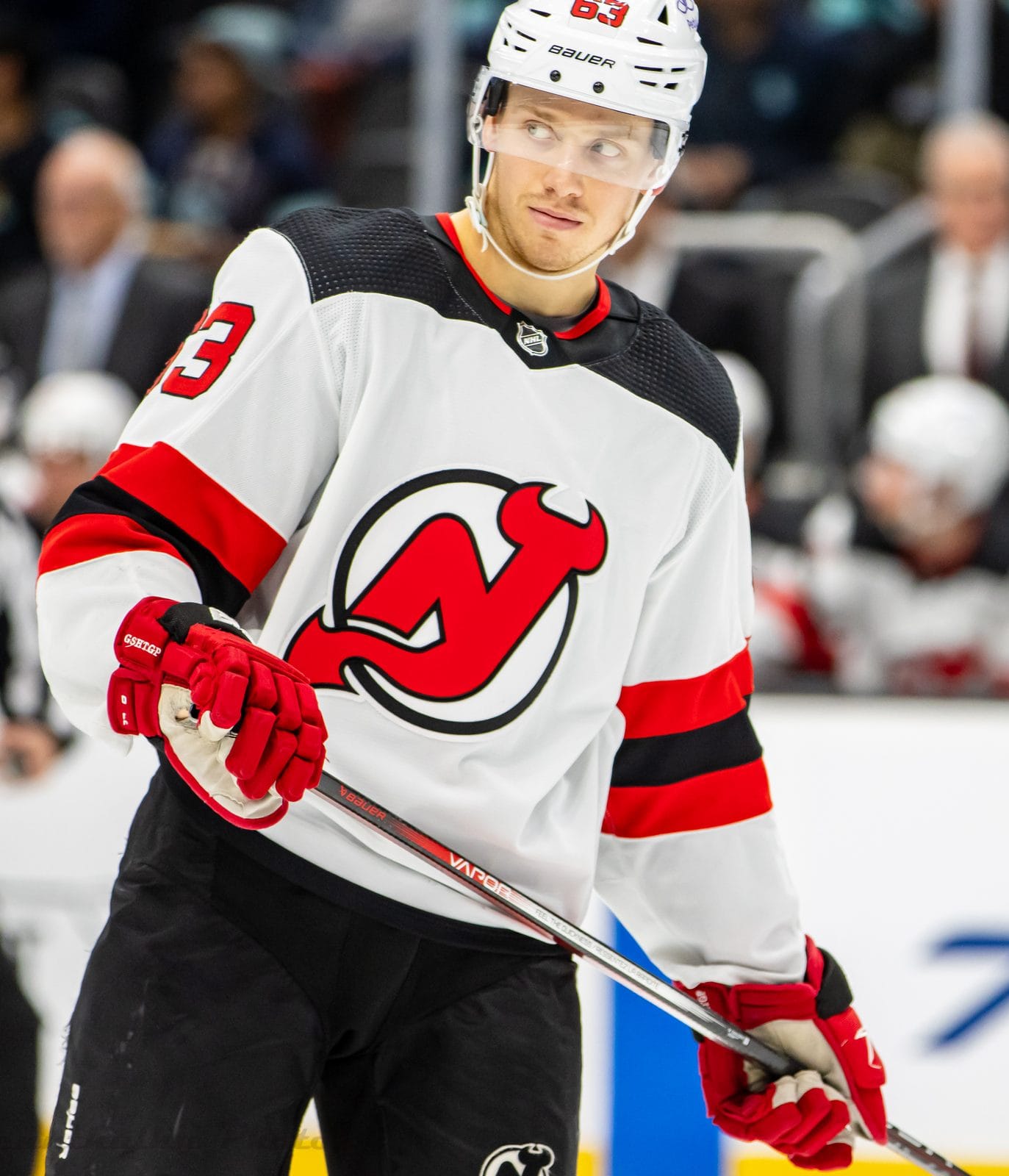 Jesper Bratt in the Devils' white road uniform with the red NJ crest and black and red stripes, No. 63, at Climate Pledge Arena in Seattle, December 7, 2023