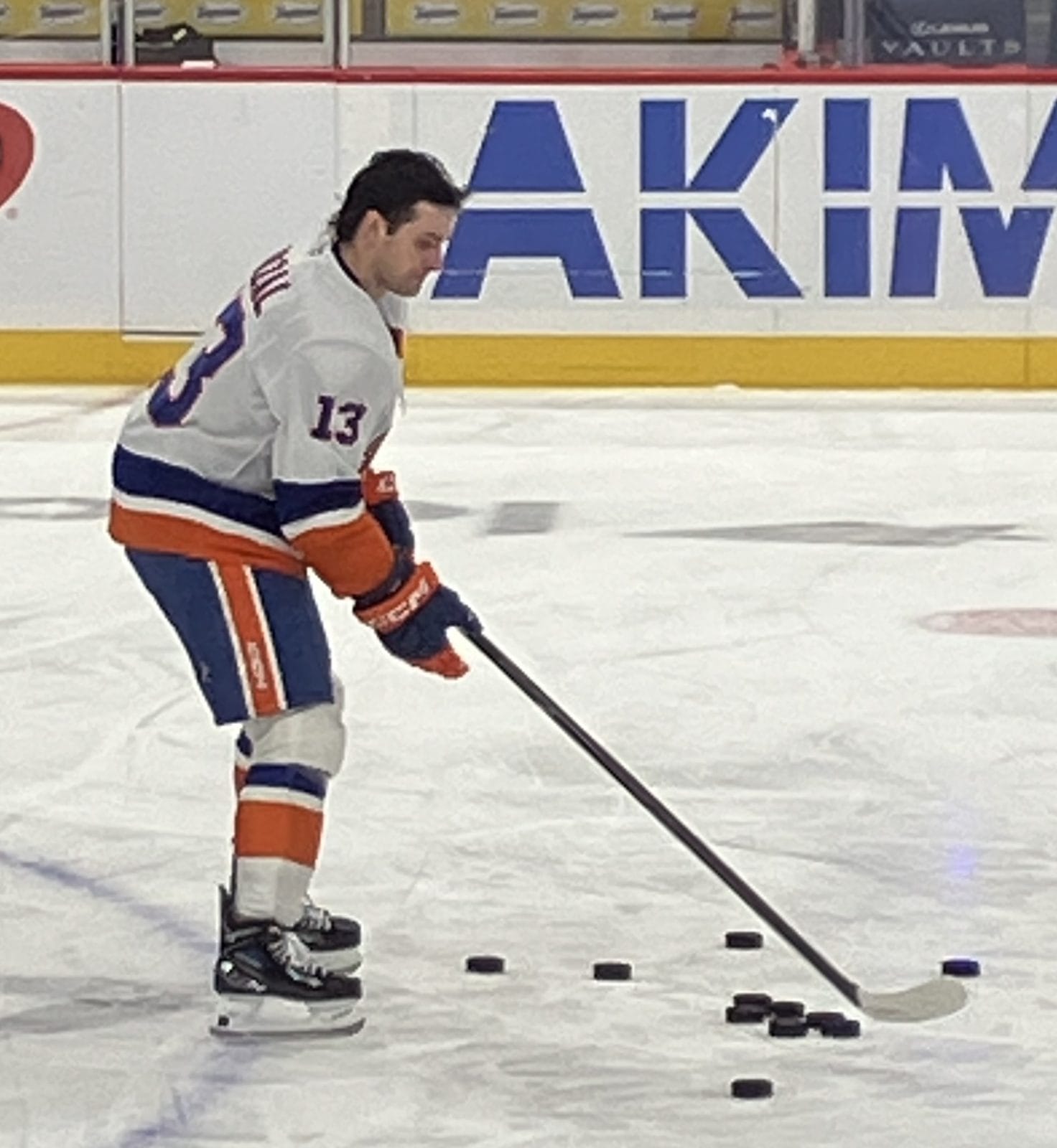 Mathew Barzal handles pucks in warmups in the Islanders' white road uniform with orange and royal blue stripes, No. 13, at Capital One Arena in Washington, February 2, 2026