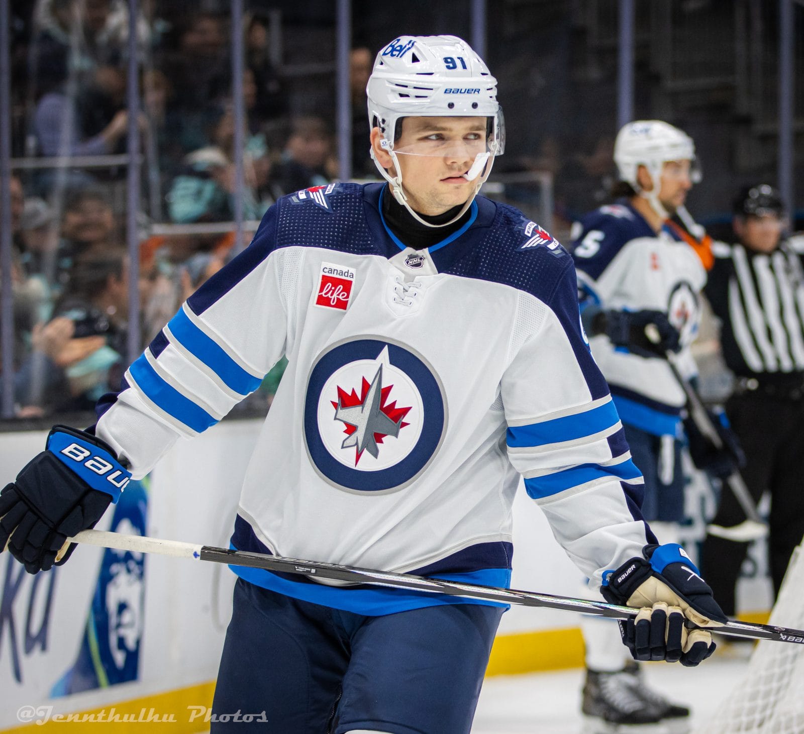 Cole Perfetti in the Jets' white road uniform with the jet-and-maple-leaf roundel crest and navy and blue stripes, No. 91, at Climate Pledge Arena in Seattle, March 8, 2024