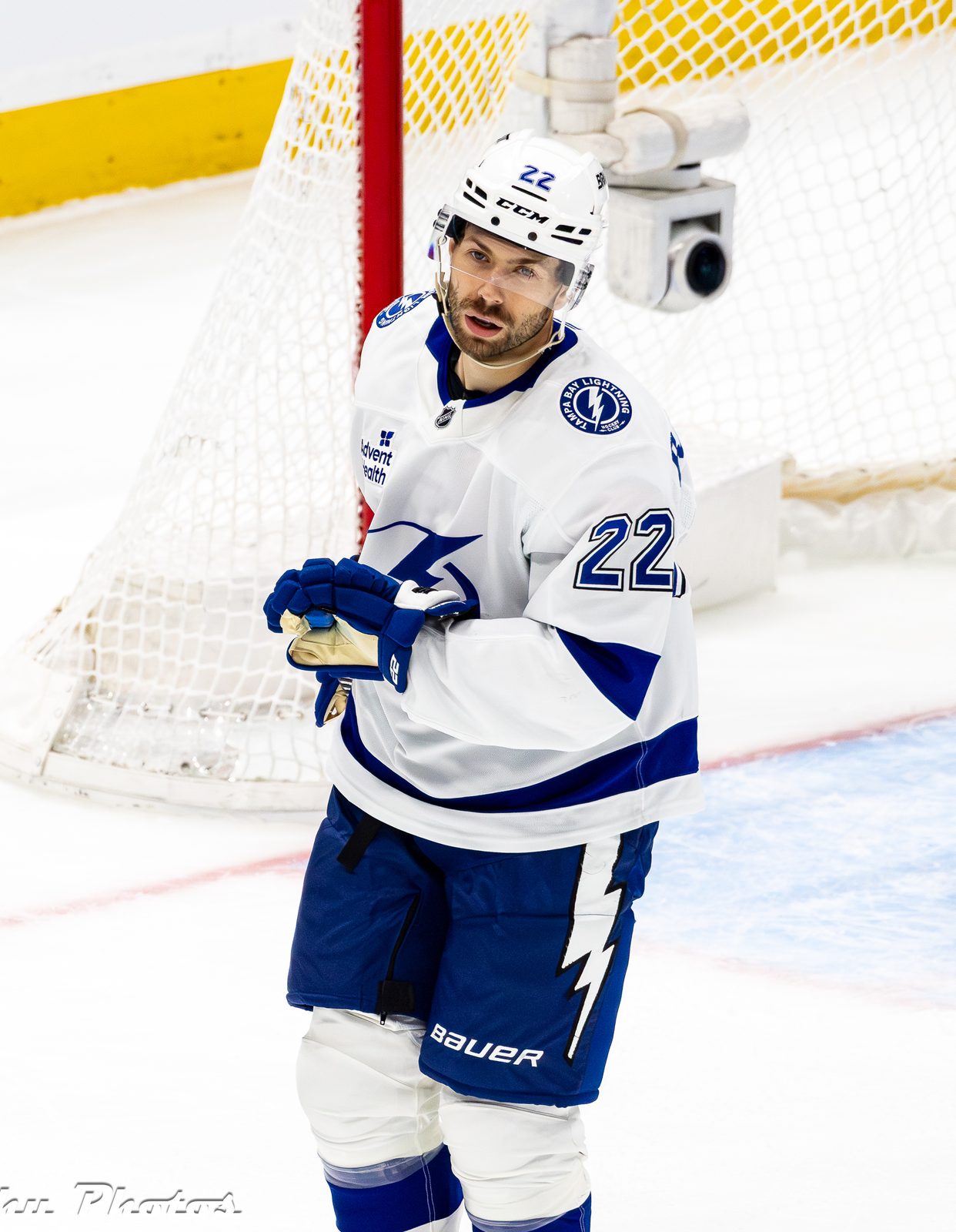 Oliver Bjorkstrand in the Lightning's white road uniform with the bolt crest and No. 22, blue pants with a lightning bolt, at Climate Pledge Arena in Seattle, March 17, 2026