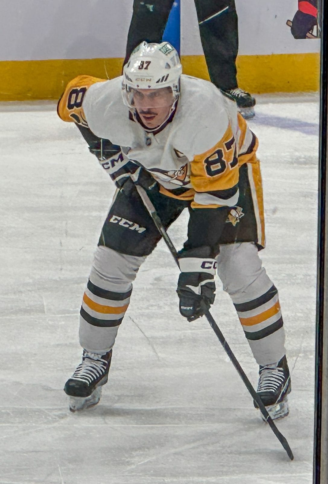 Captain Sidney Crosby waits for a faceoff in the Penguins' white road uniform with the skating-penguin crest and black and gold trim, No. 87, at Nationwide Arena in Columbus, November 15, 2024