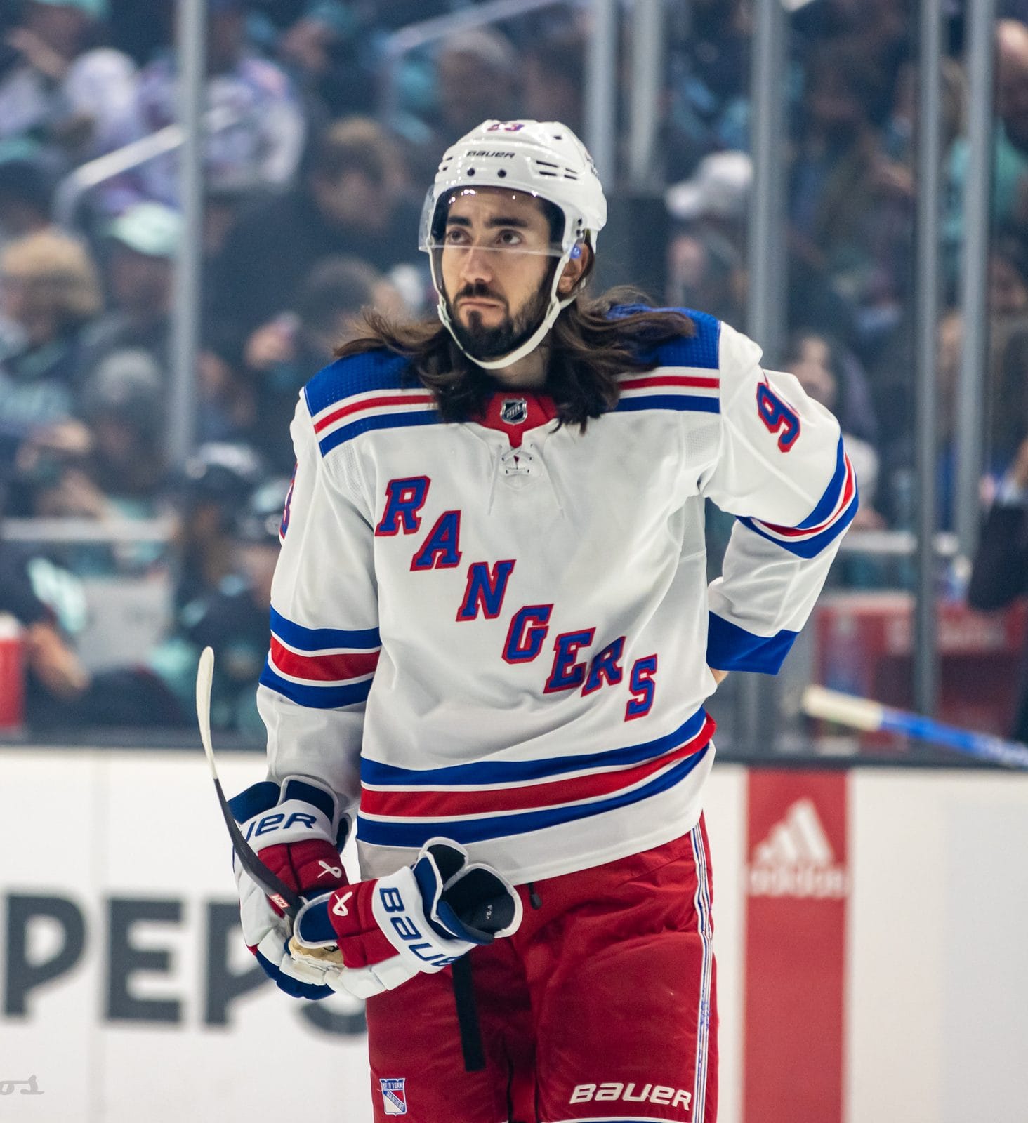 Mika Zibanejad in the Rangers' white road uniform with the diagonal RANGERS wordmark and red and blue stripes, No. 93, at Climate Pledge Arena in Seattle, October 21, 2023