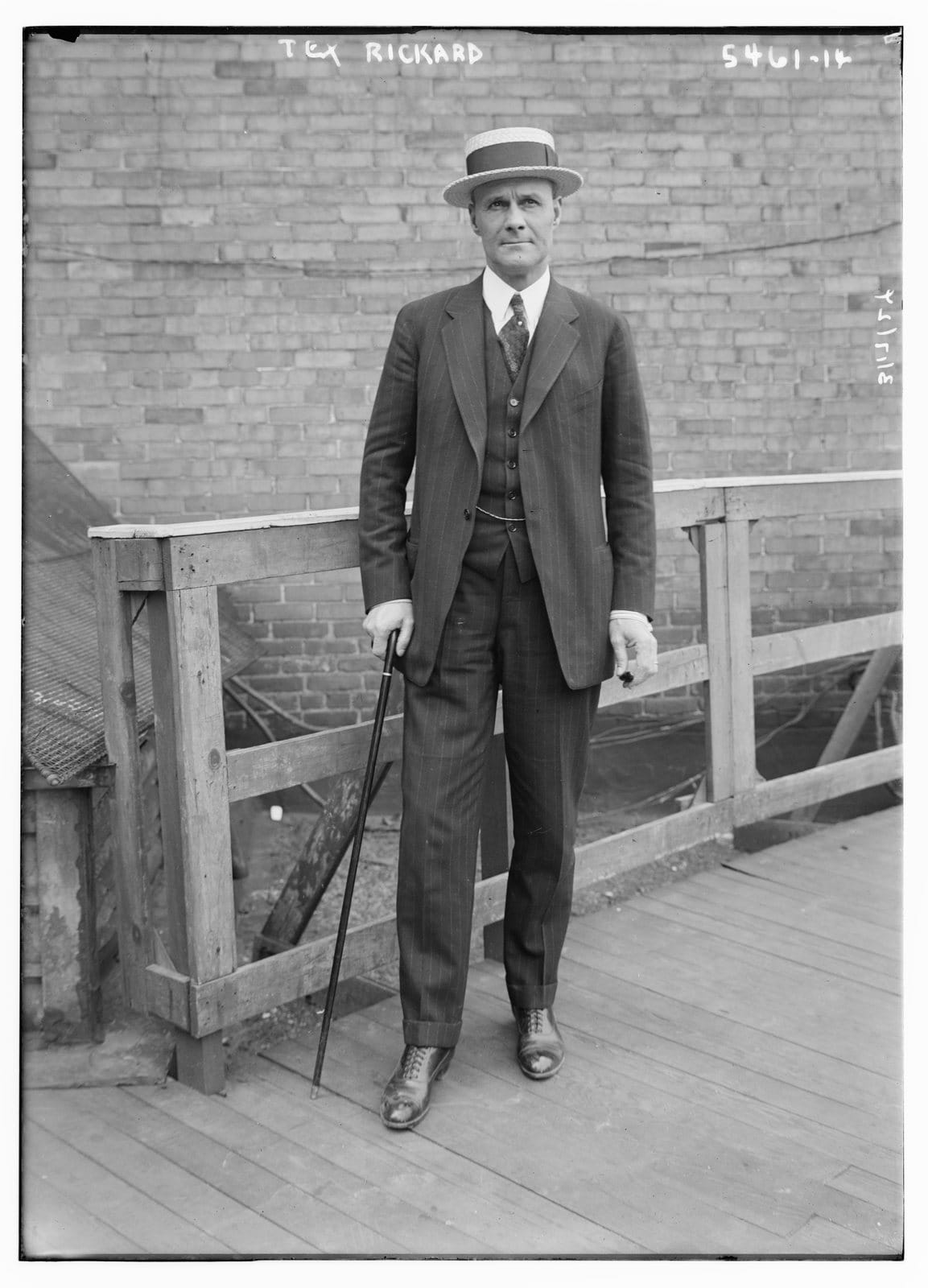 Boxing promoter Tex Rickard, the Madison Square Garden boss whose name gave 'Tex's Rangers' their nickname, in a suit and straw boater with a cane