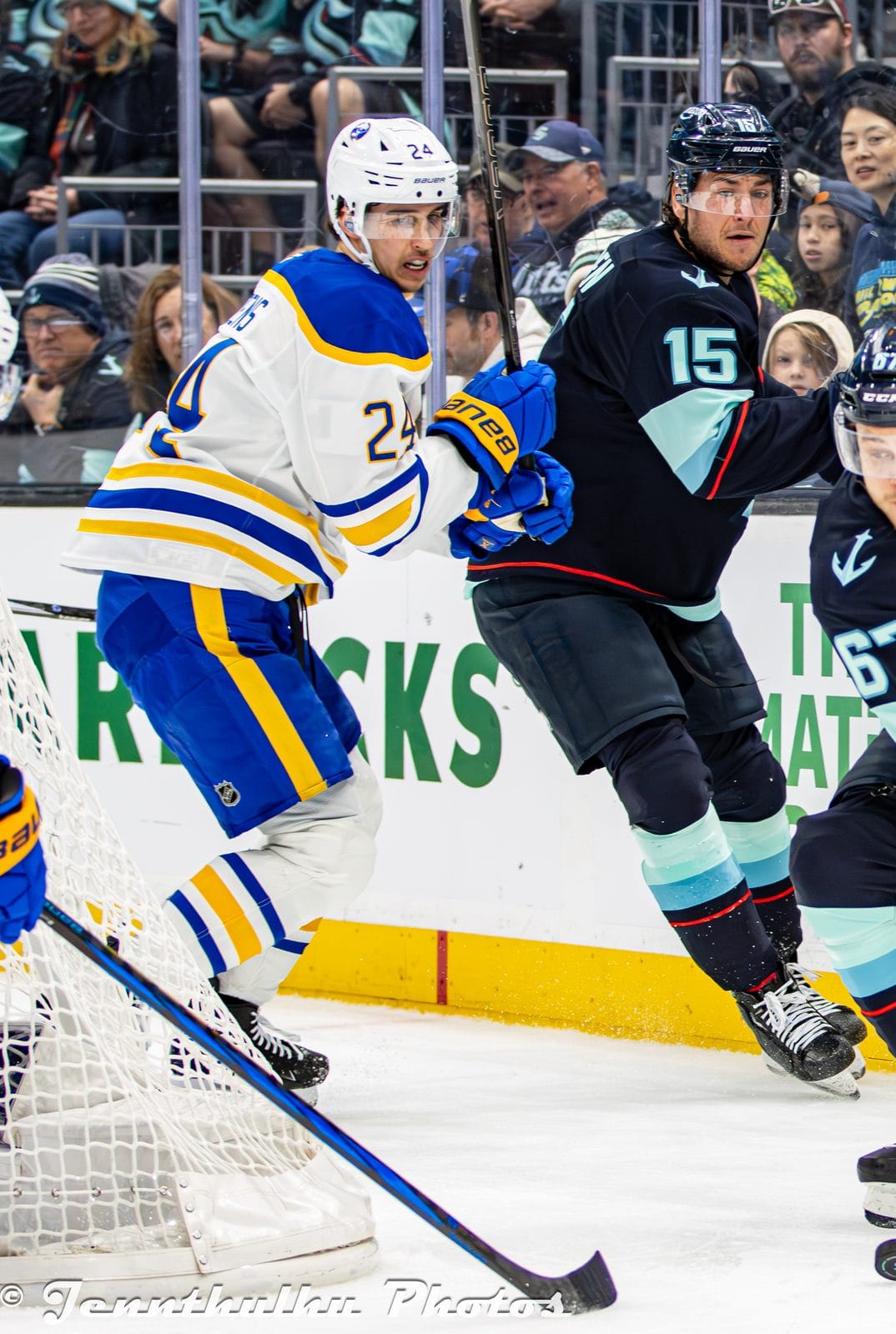 Dylan Cozens in the Sabres' white road uniform with royal blue and gold trim, No. 24, chases the play at Climate Pledge Arena in Seattle, January 20, 2025