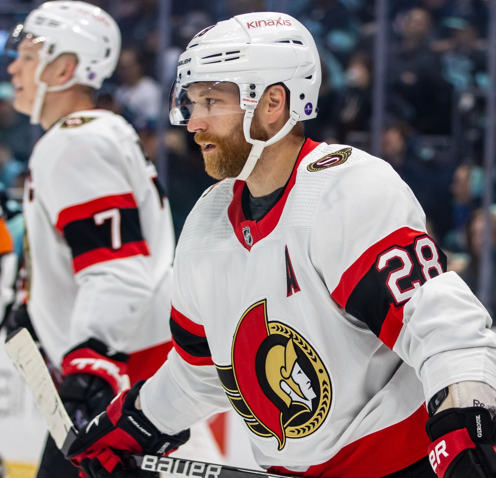 Claude Giroux in the Senators' white road uniform with the Roman senator crest, red and black arm stripes and an A over No. 28, at Climate Pledge Arena in Seattle, March 9, 2023