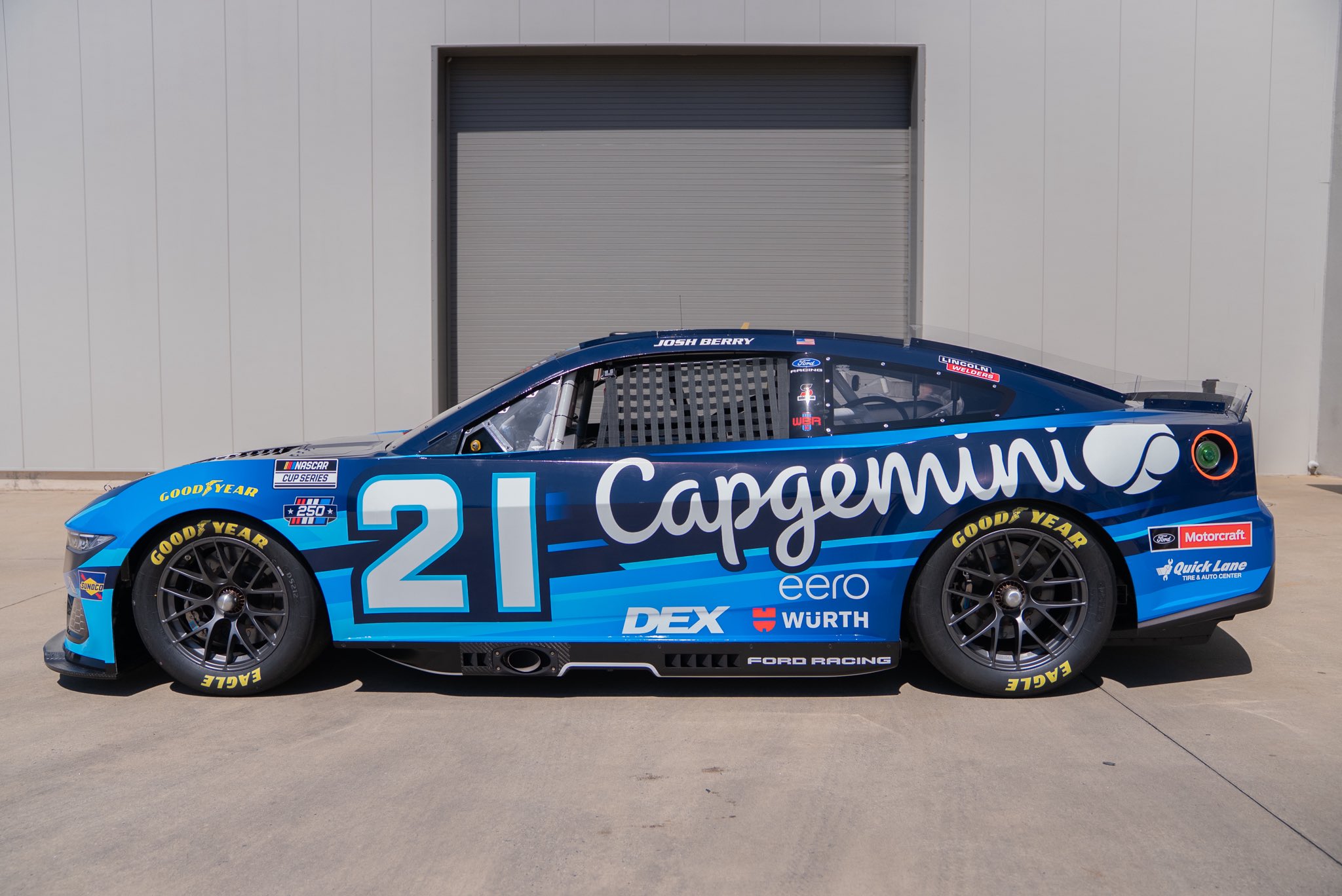 Josh Berry #21 Wood Brothers Racing Capgemini Ford Mustang Dark Horse paint scheme in two-tone deep navy and cyan blue with Capgemini script wordmark on the door for 2026 NASCAR Cup Series