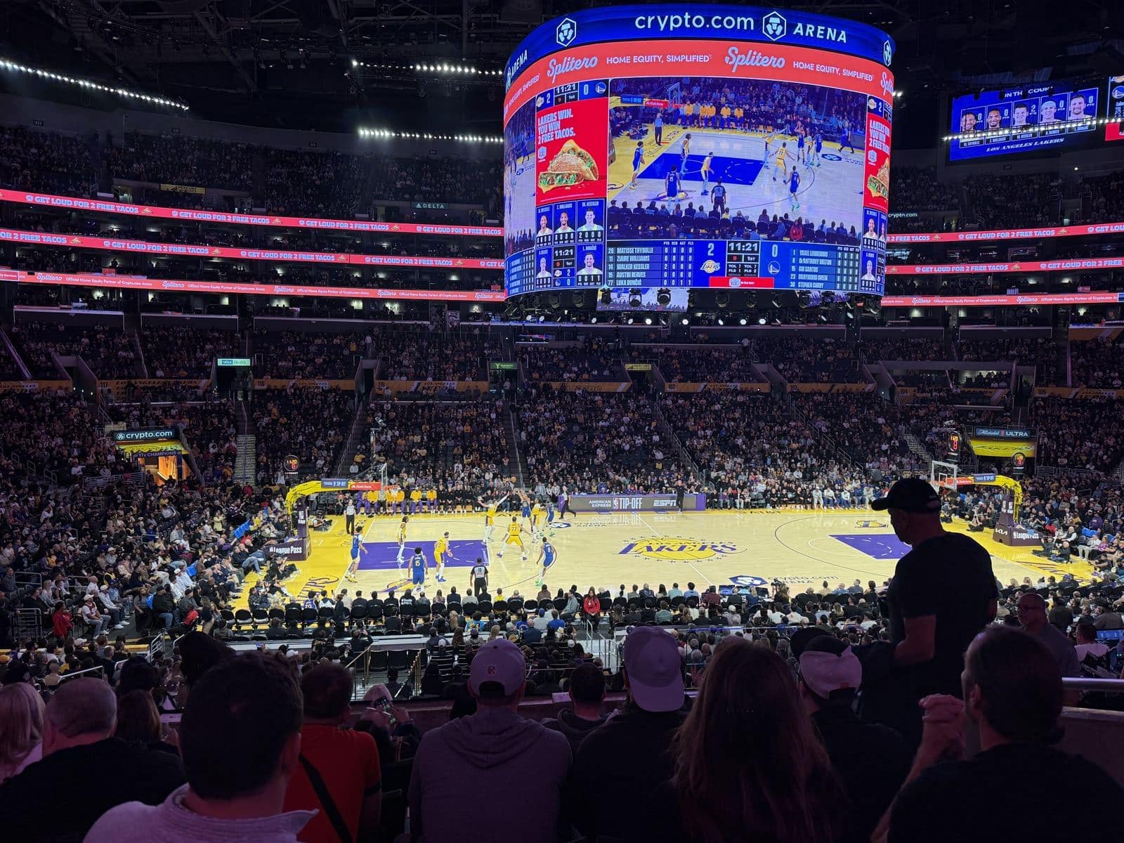 Lakers in gold Icon jerseys and Warriors in blue Icon jerseys during the first quarter of the 2026-27 home opener at Crypto.com Arena