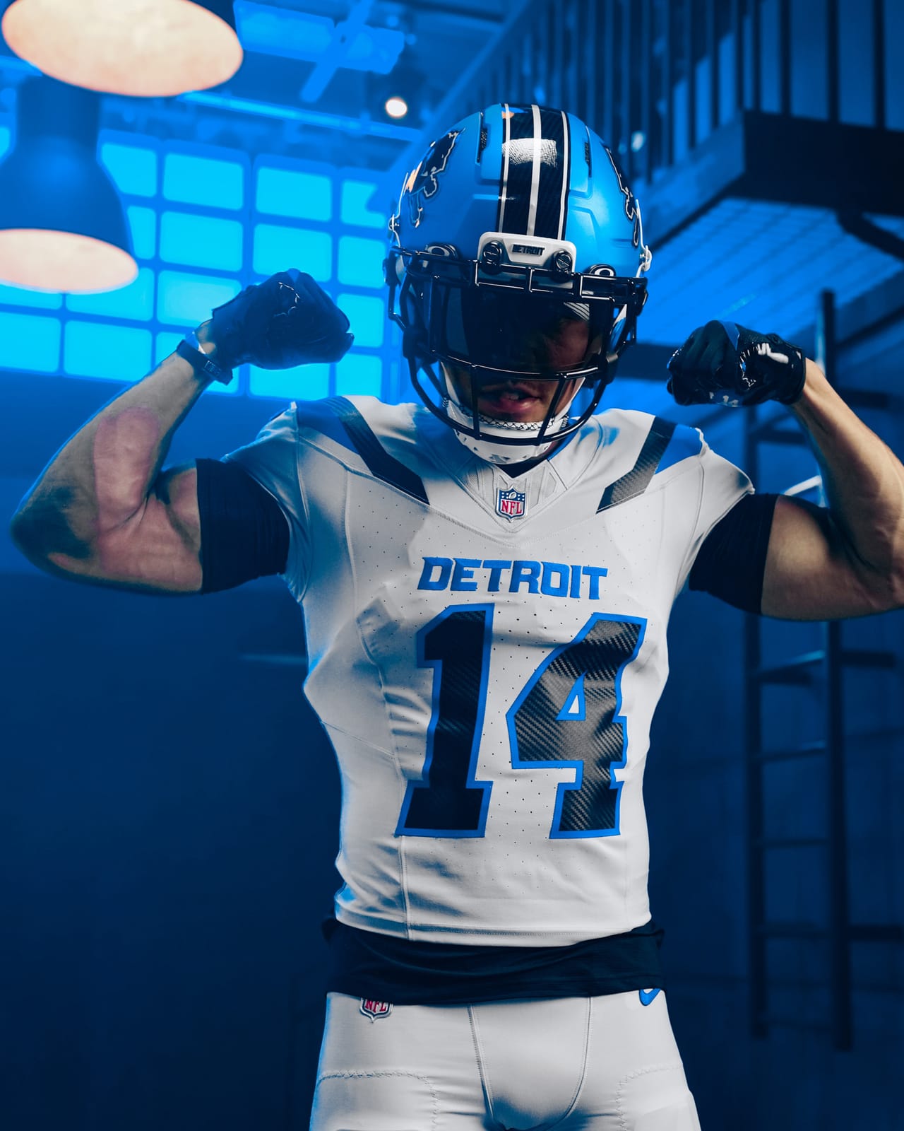 Detroit Lions Rivalries uniform, player flexing in the bone white jersey with carbon fiber numbers and blue trim