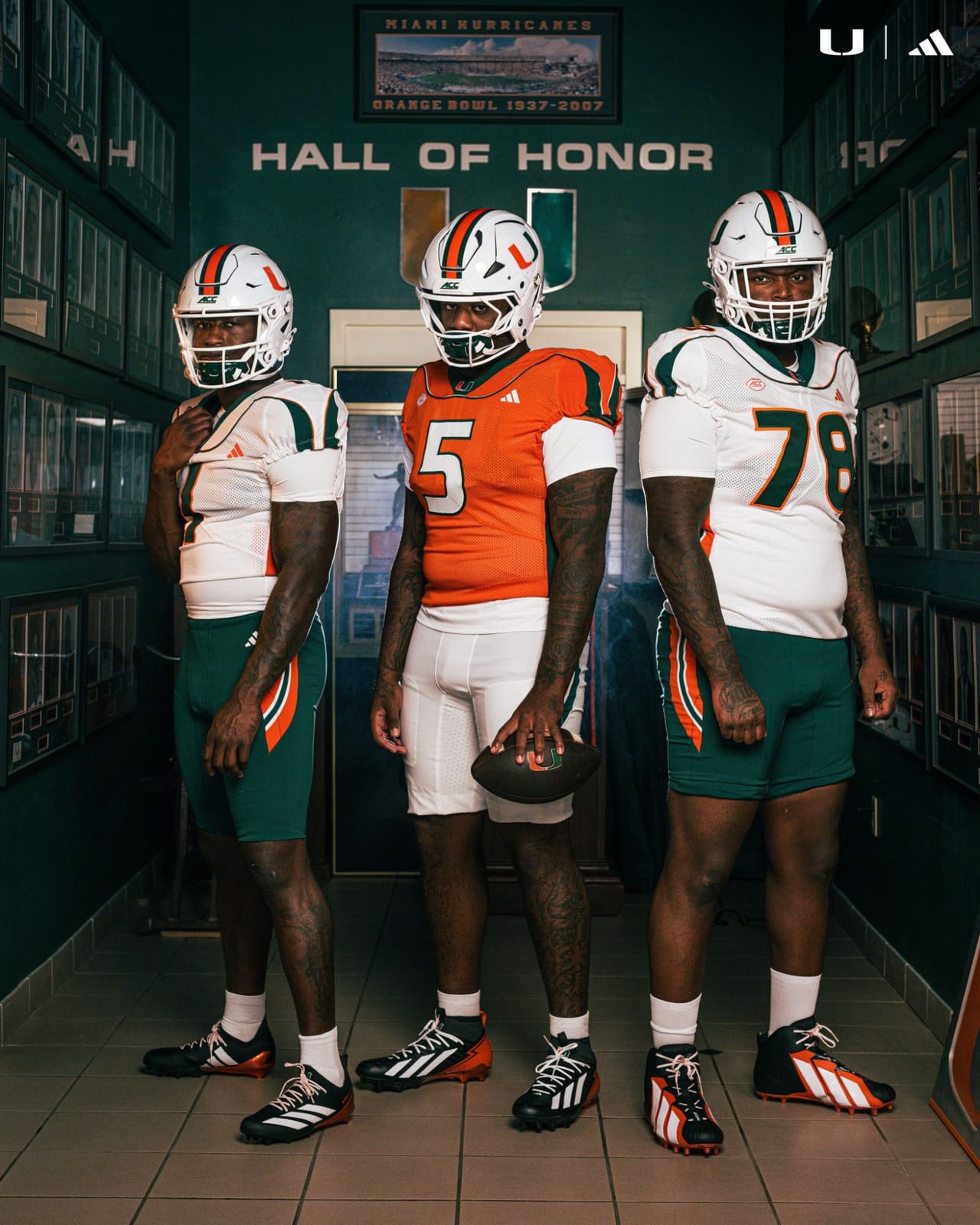 Full length view of the Miami 2001 throwback uniforms showing the white jerseys over green pants and the orange jersey over white pants