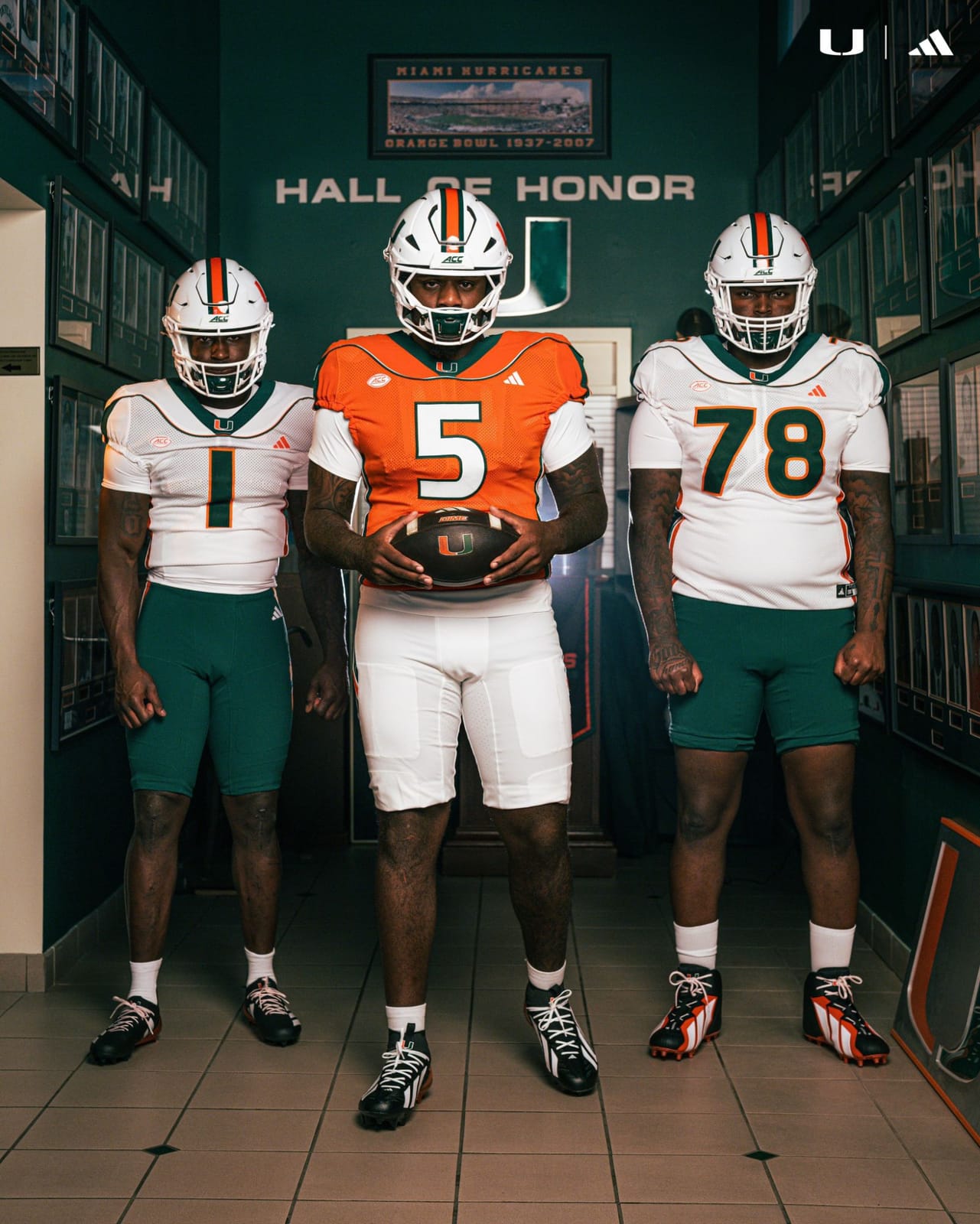Miami players in the 2001 throwback uniforms in the Hall of Honor, beneath the Orange Bowl 1937-2007 photograph