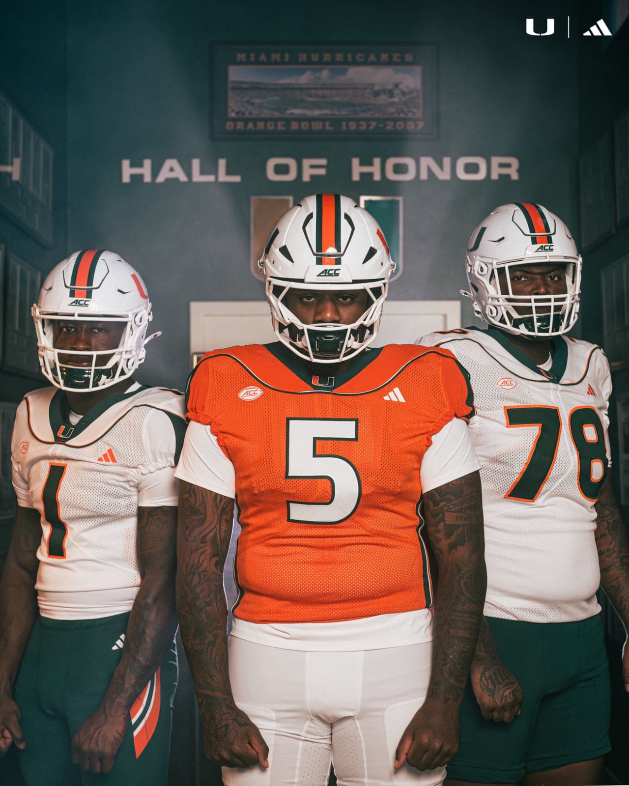 Close view of the Miami 2001 throwback jerseys, showing the green shoulder yoke with orange trim on the white jersey and the green and white yoke on the orange jersey