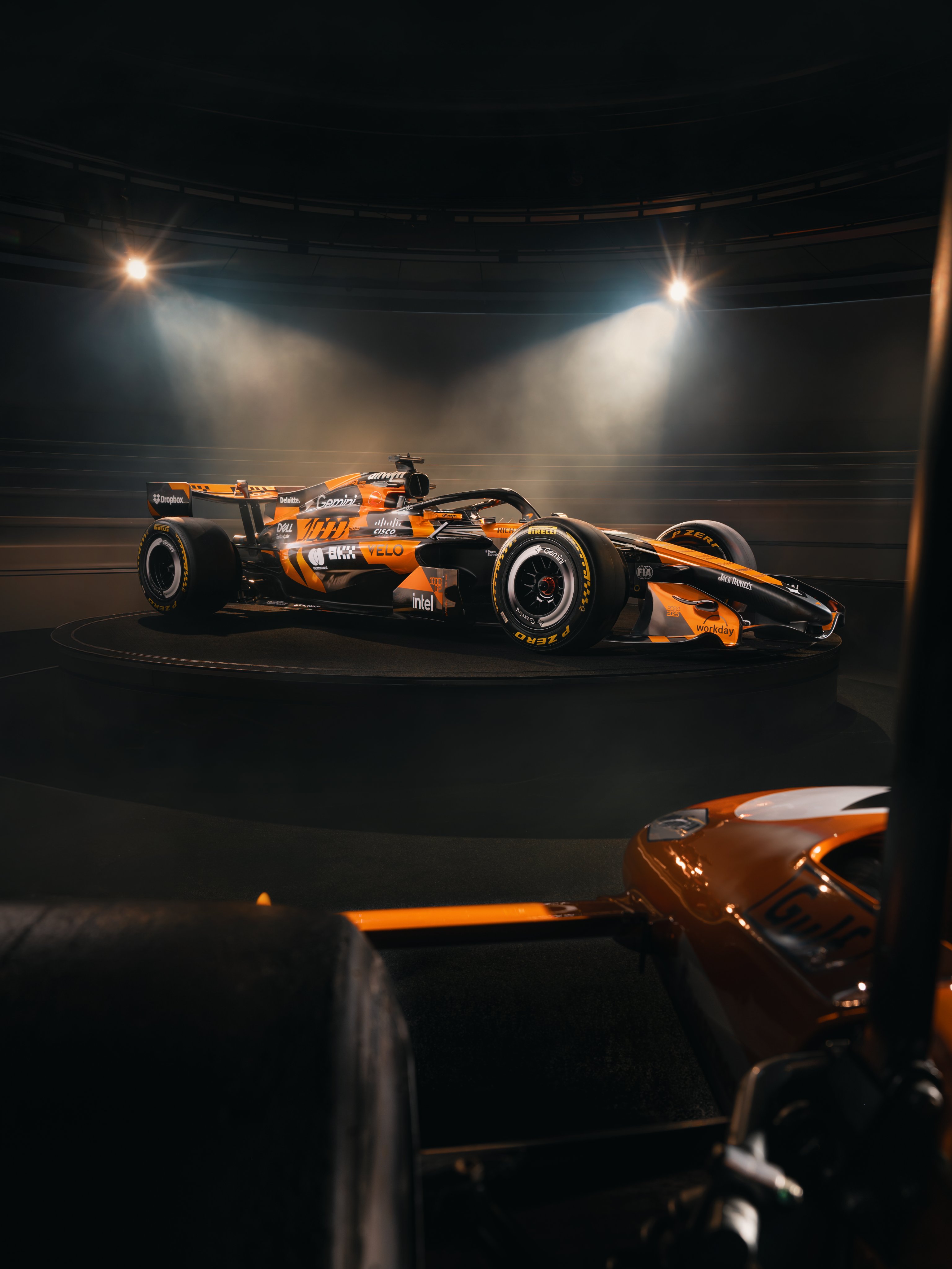 McLaren F1 Monaco Grand Prix 2026 special livery detailed studio shot of the MCL40 chassis from a low side angle showing the 1000th GP retro paint scheme and the sponsor branding layered against the matte black base