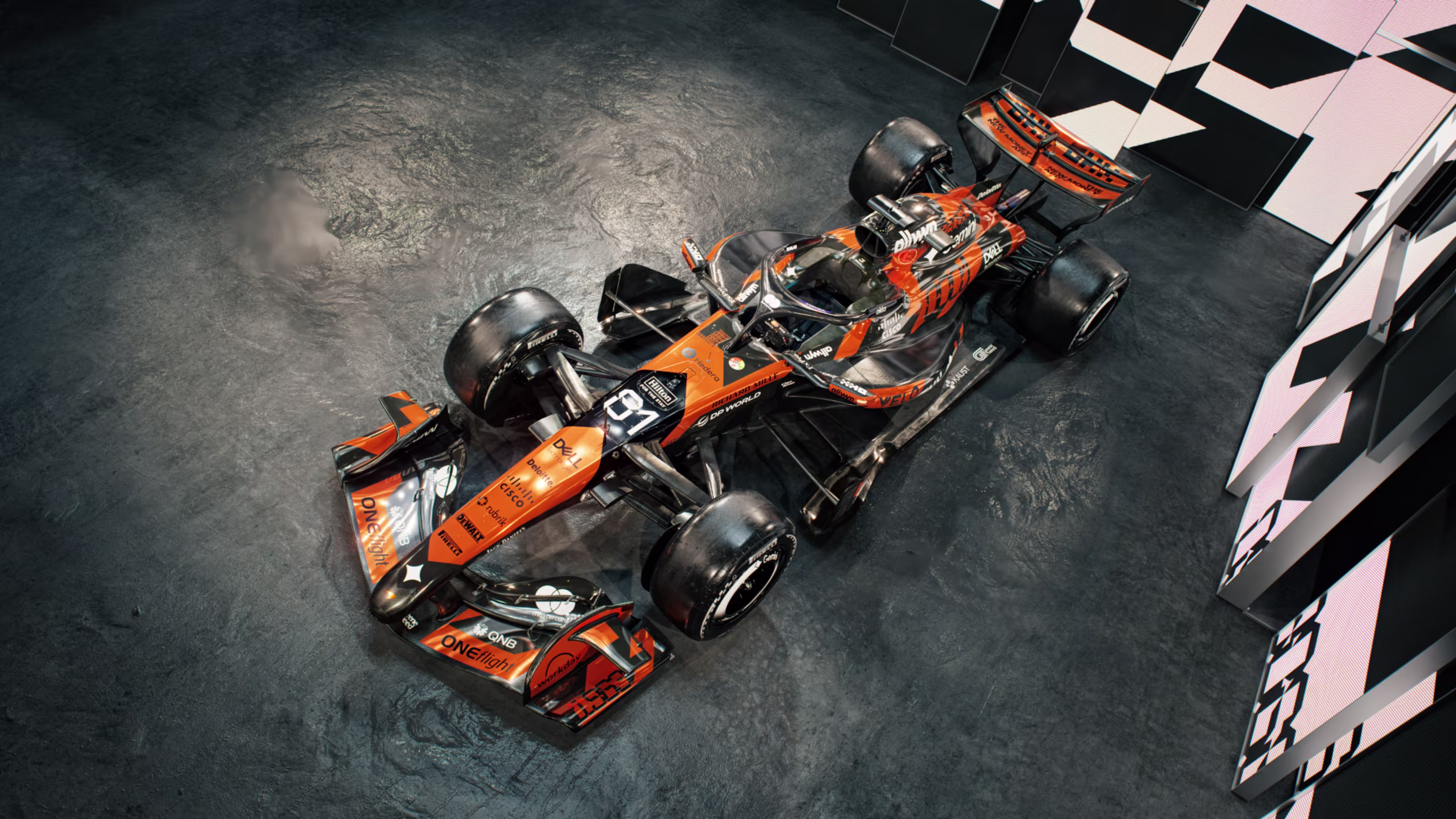 McLaren F1 Monaco Grand Prix 2026 special livery aerial overhead three-quarter view of the MCL40 showing the full retro orange-and-black layout across the engine cover, sidepods, and floor with the 1976 numerals visible on the rear panel