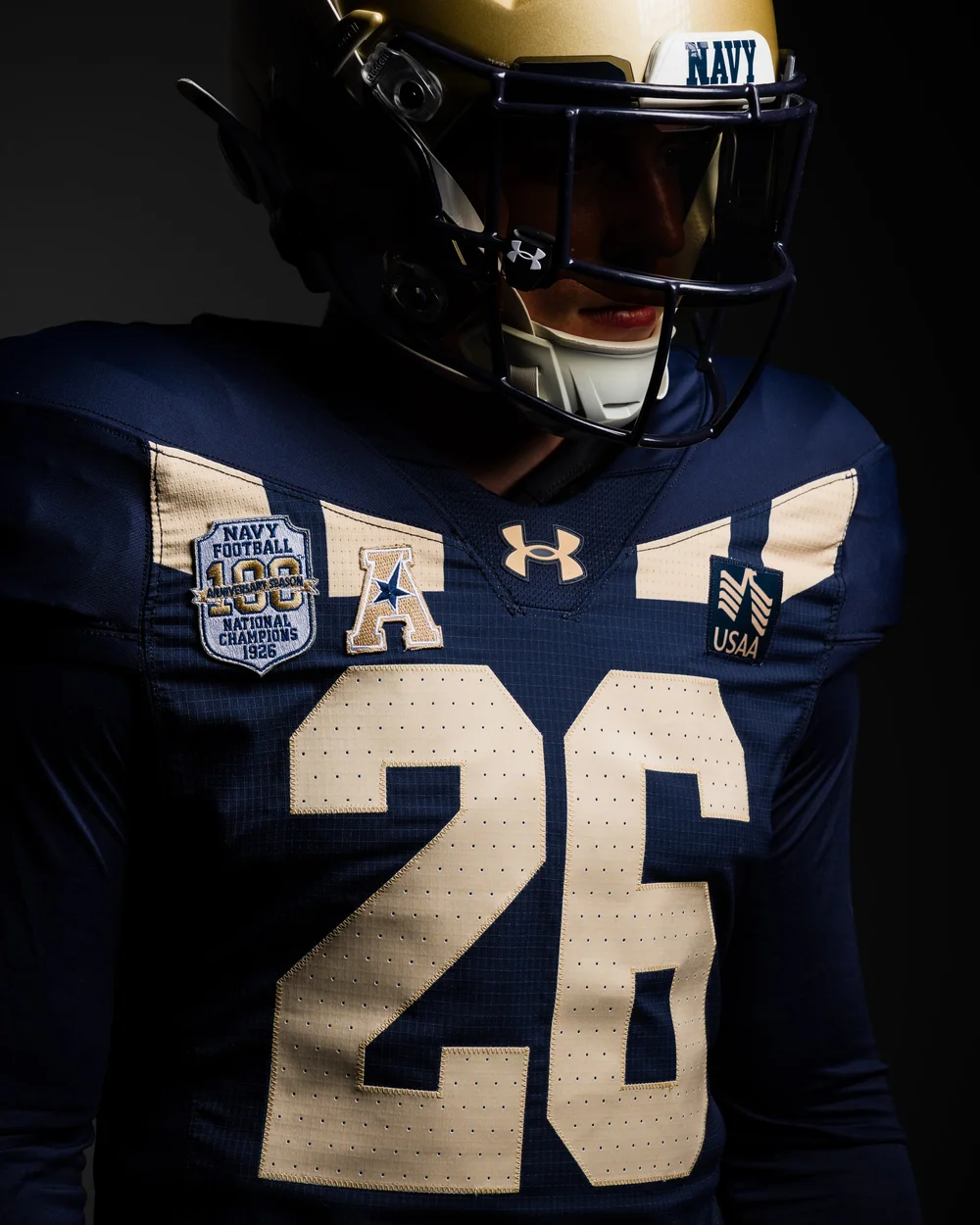 Detail of the Navy 1926 centennial jersey showing the gold chevron stripes, gold numerals and the 100th anniversary national champions patch