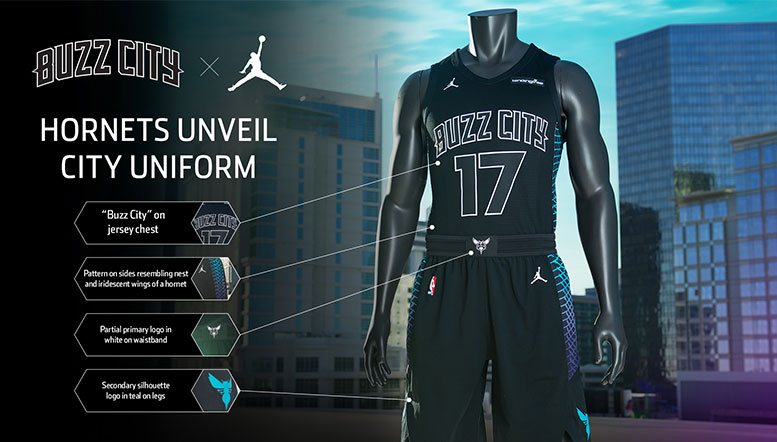 Charlotte Hornets 2017-18 Buzz City City Edition uniform, black with an outlined BUZZ CITY wordmark and teal hornet-wing pattern side panels, returning for 2026-27