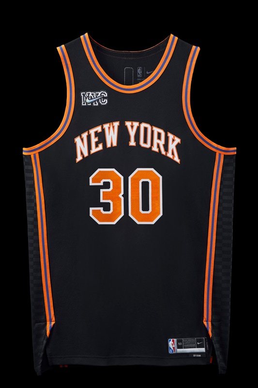 New York Knicks 2021-22 City Edition jersey designed with Kith, black with an orange NEW YORK wordmark outlined in white and blue and orange trim, returning for 2026-27