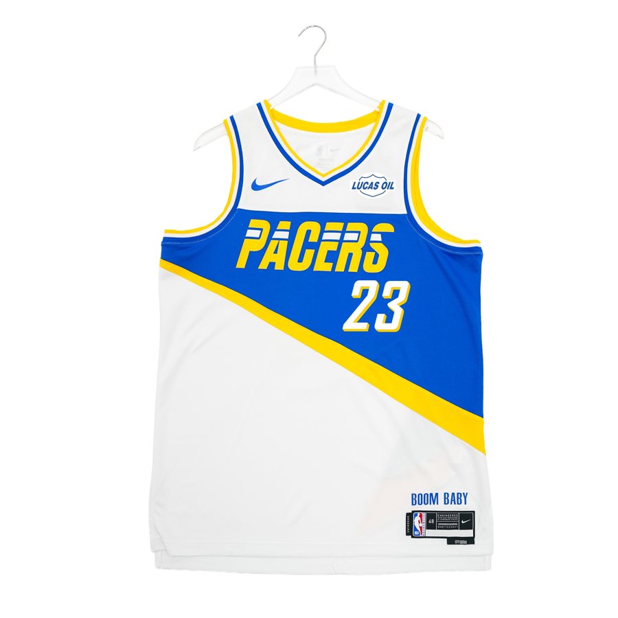 Indiana Pacers 2025-26 Moments Mixtape City Edition jersey, white with a royal blue diagonal band carrying a gold PACERS wordmark and gold trim, returning for 2026-27