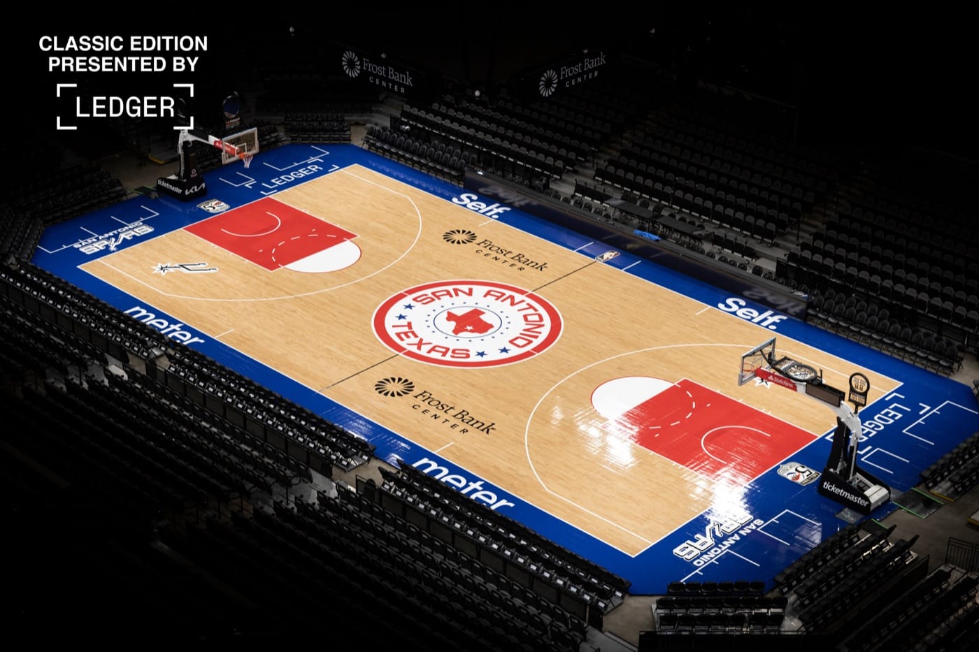 San Antonio Spurs 2026-27 Classic Edition court at Frost Bank Center: blue apron, red lanes and a SAN ANTONIO TEXAS center circle