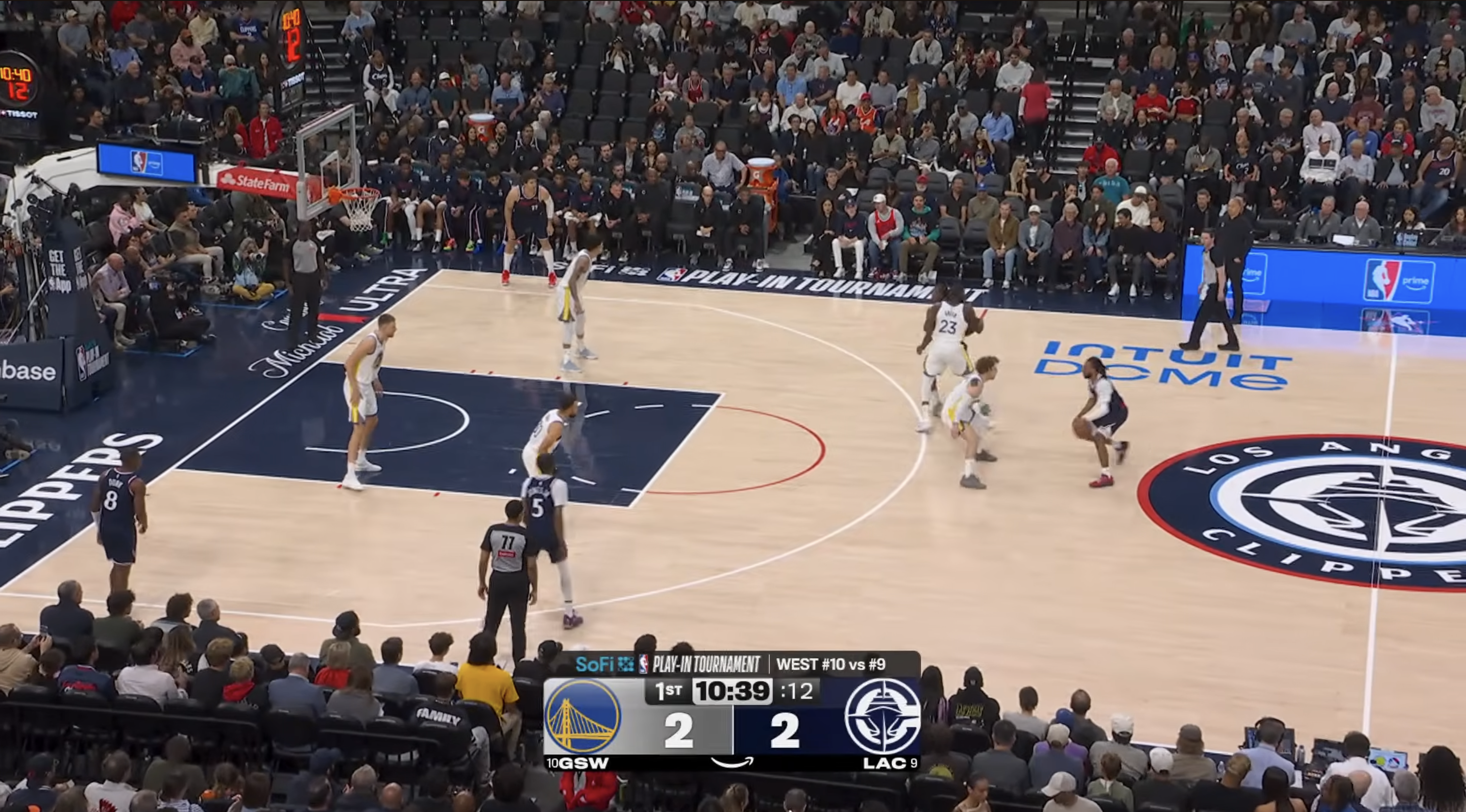 Golden State Warriors white jerseys vs LA Clippers dark blue jerseys Play-In Tournament 2026 gameplay at Intuit Dome