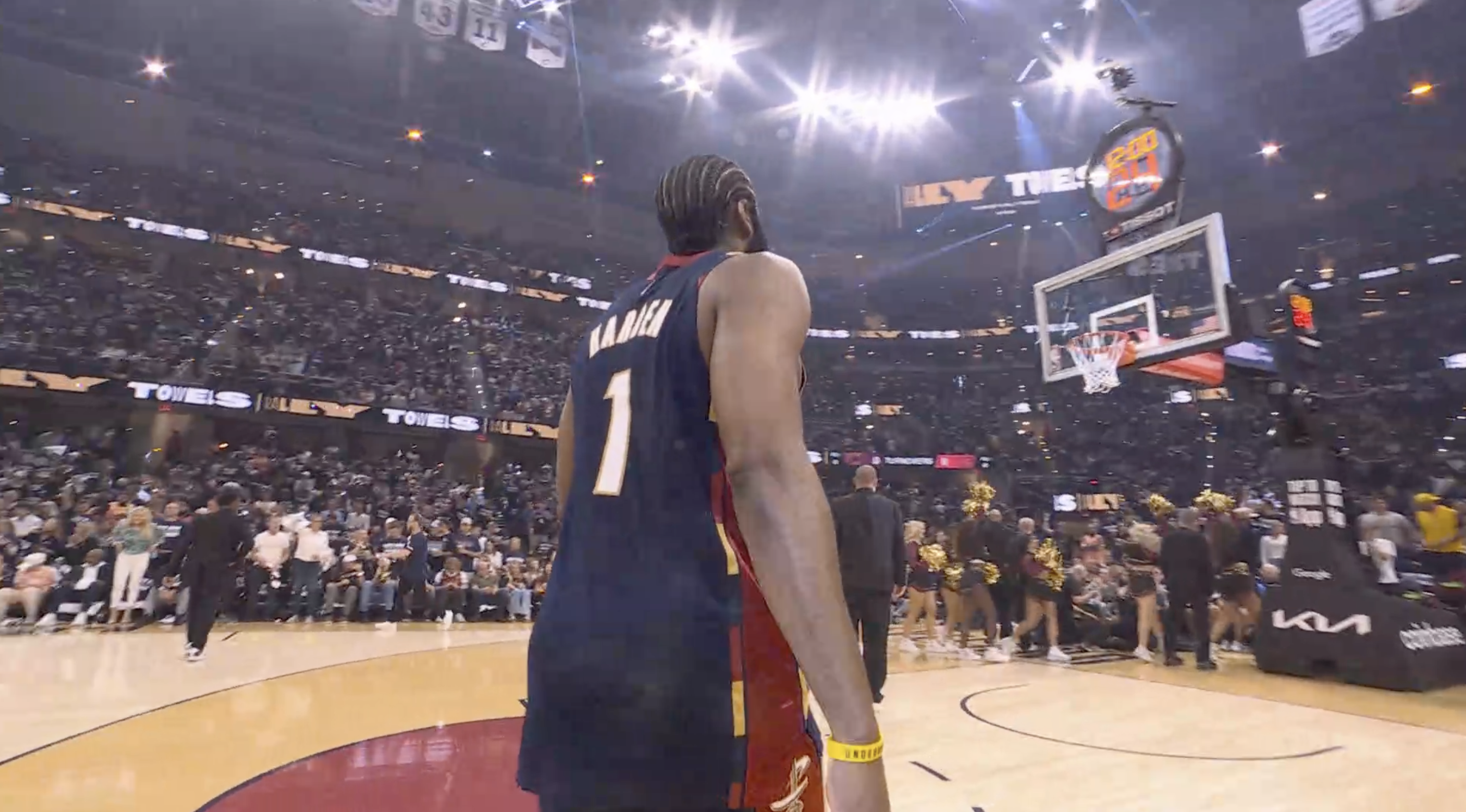 James Harden in his Clippers number 1 jersey in the 2026 NBA Playoffs Round 1 with the stanchion in view showing standard regular season sponsor branding instead of the NBA Playoffs logo, the second straight postseason without it