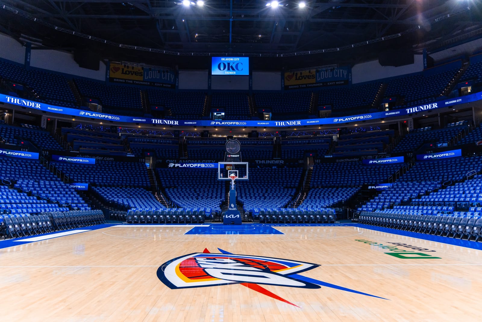 Oklahoma City Thunder Paycom Center playoff arena setup with PLAYOFFS 2026 LED ribbon branding Thunder banners and OKC center scoreboard 2026 NBA Playoffs Round 1