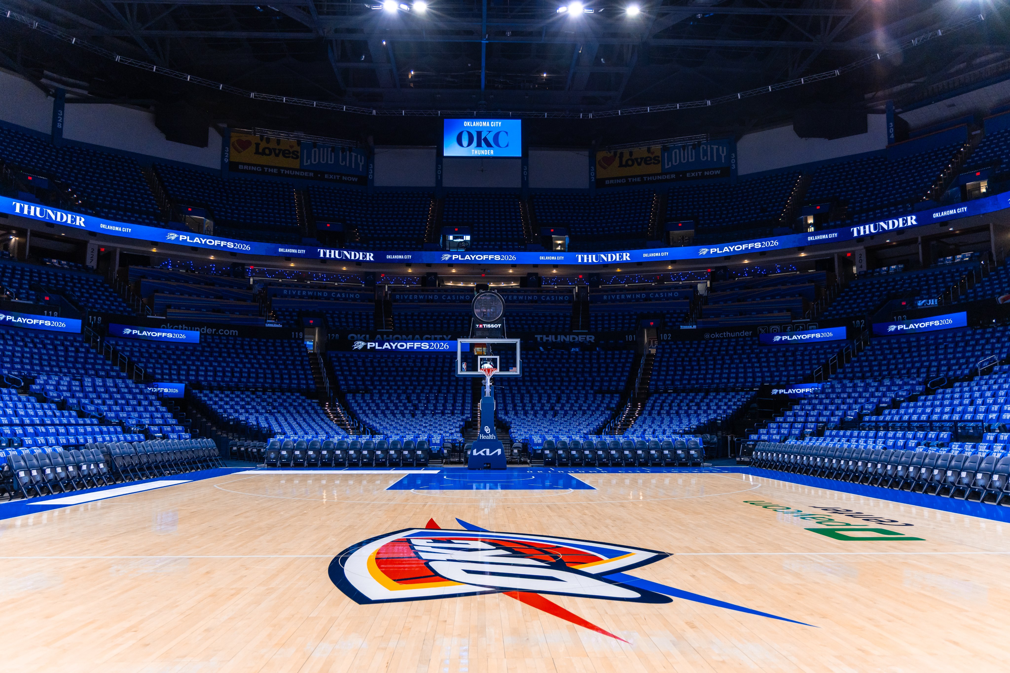 Oklahoma City Thunder Paycom Center playoff arena setup with PLAYOFFS 2026 LED ribbon branding Thunder banners and OKC center scoreboard 2026 NBA Playoffs Round 1