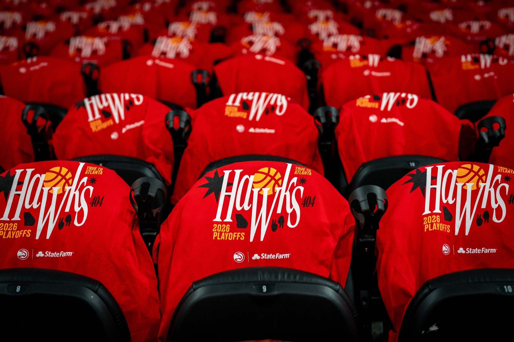 Atlanta Hawks red playoff t-shirts laid out on every seat at State Farm Arena for Game 3 against the New York Knicks in the 2026 NBA Playoffs Round 1