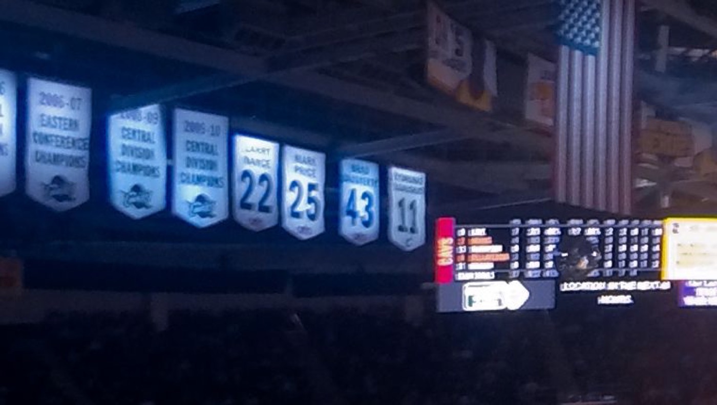 The real Zydrunas Ilgauskas No. 11 banner hanging beside the retired numbers of Larry Nance, Mark Price and Brad Daugherty in the Cavaliers arena rafters, 2014
