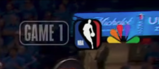 NBC top-right corner ticker for the 2026 NBA Western Conference Finals Game 1 broadcast showing a Game 1 pill the NBA logo and the NBC Peacock logo with no Western Conference Finals branding visible