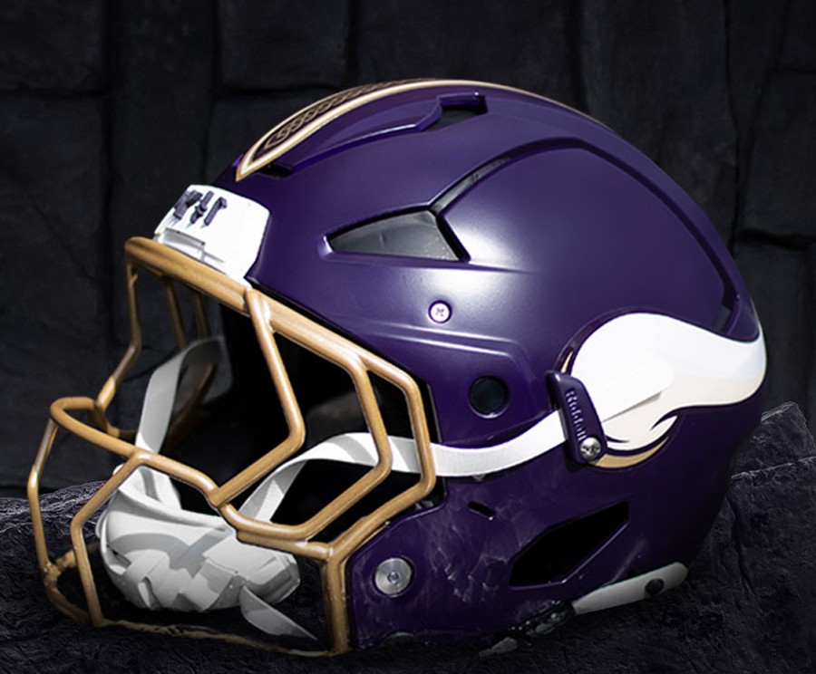 Minnesota Vikings Rivalries helmet, matte deep purple shell with a gold face mask, gold knot crown stripe, the white horn, and SKOL in rune characters on the bumper
