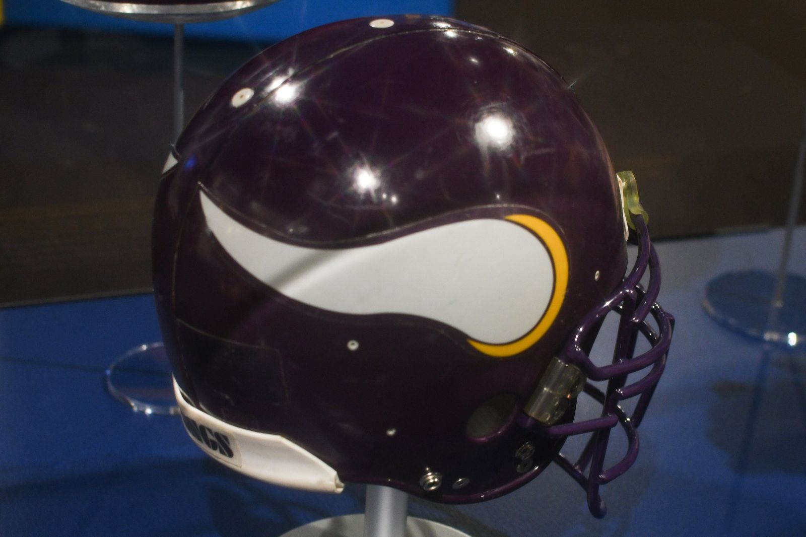 A purple Minnesota Vikings helmet with the white and gold horn logo on the side, on display at the Pro Football Hall of Fame