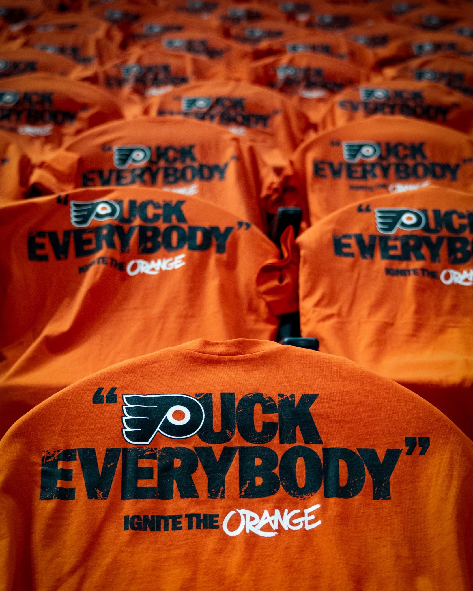 Philadelphia Flyers orange Puck Everybody Ignite the Orange playoff t-shirts laid out on every seat at Wells Fargo Center for Game 6 against the Pittsburgh Penguins in the 2026 NHL Stanley Cup Playoffs Round 1